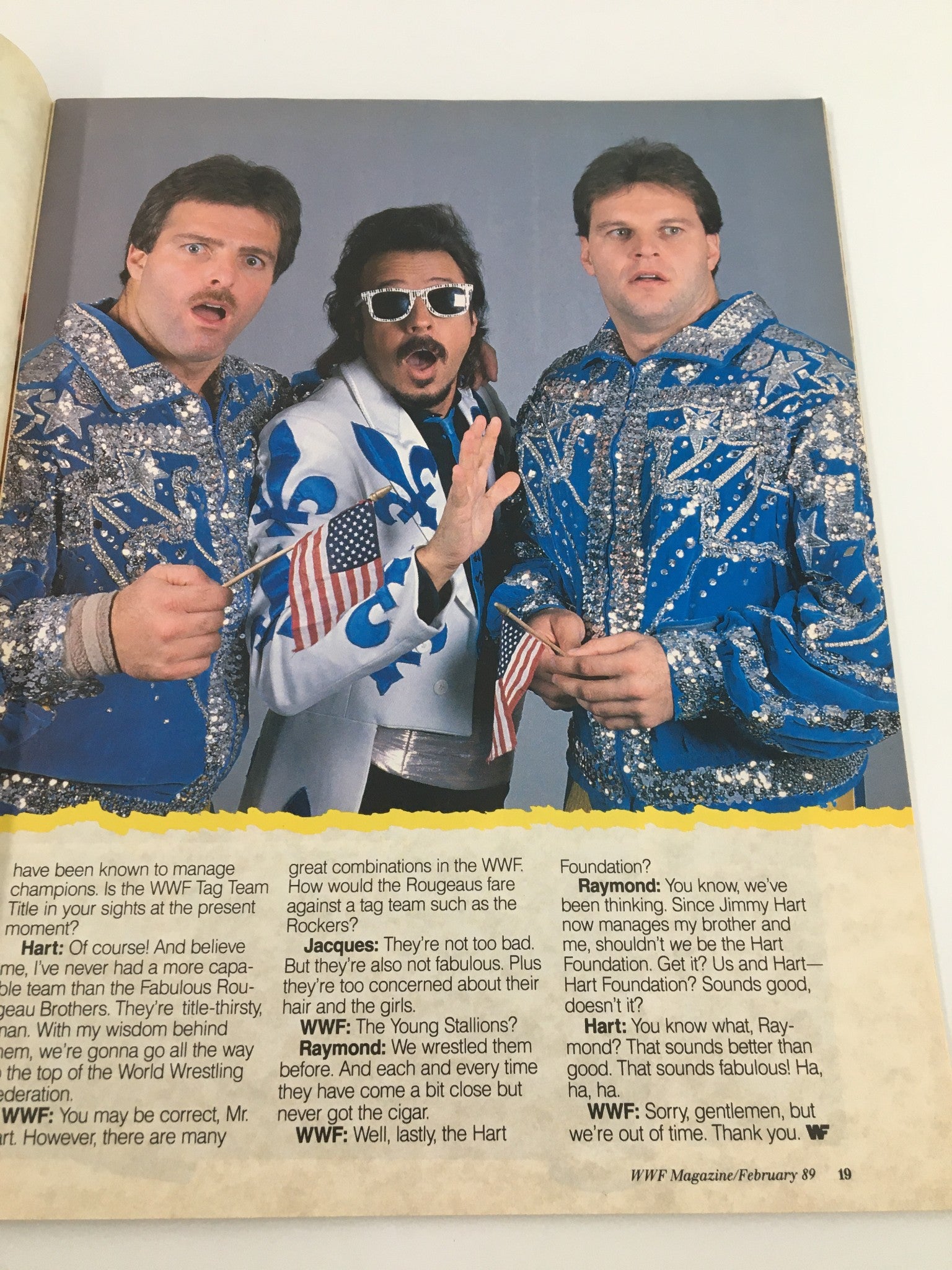 WWF Magazine February 1989 showcasing the Rougeo Brothers in a playful pose, essential figures in the world of wrestling.