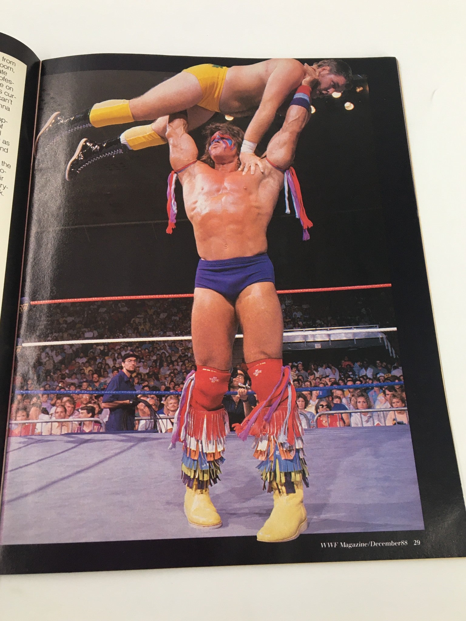 Dramatic action shot from VTG WWF Magazine December 1988 featuring a wrestler lifting an opponent in an impressive display of strength.