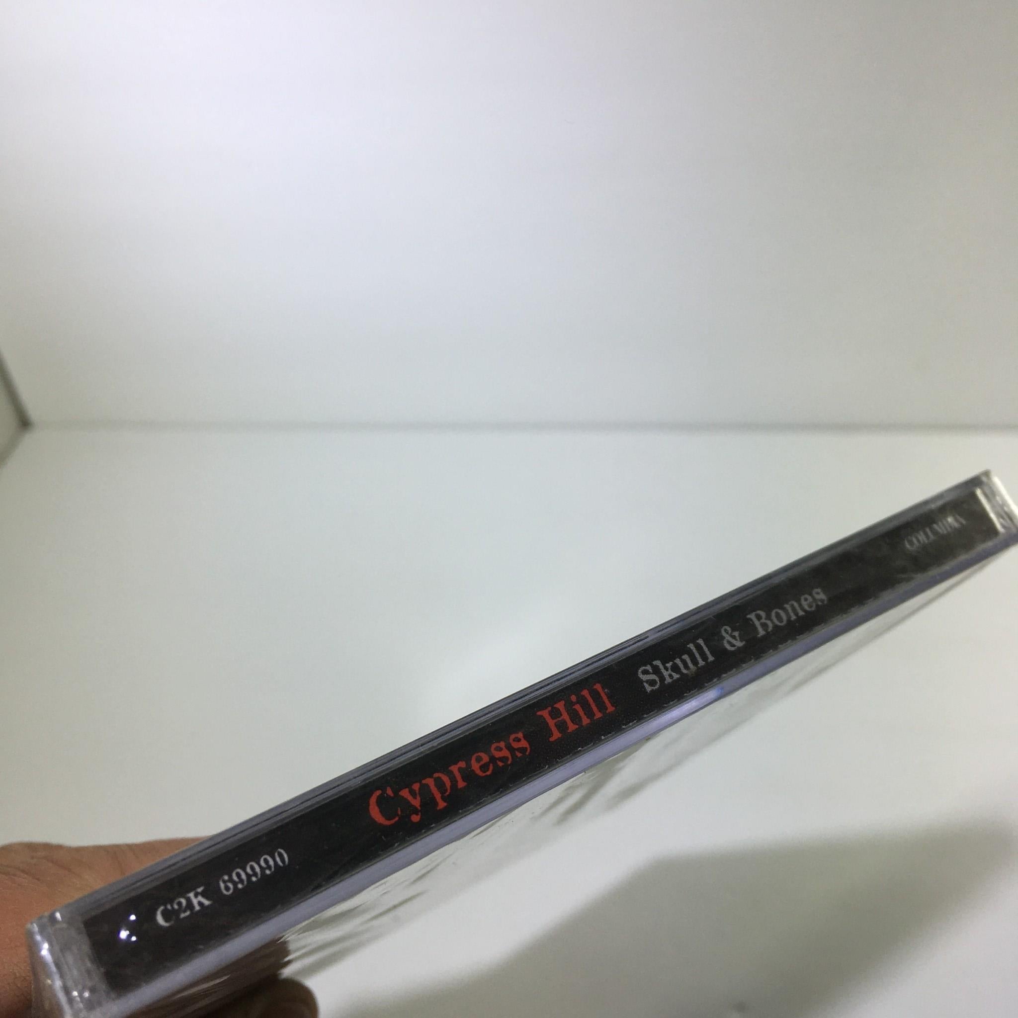 Side view of the 'Skull & Bones' CD by Cypress Hill, displaying the album title and artist's name.