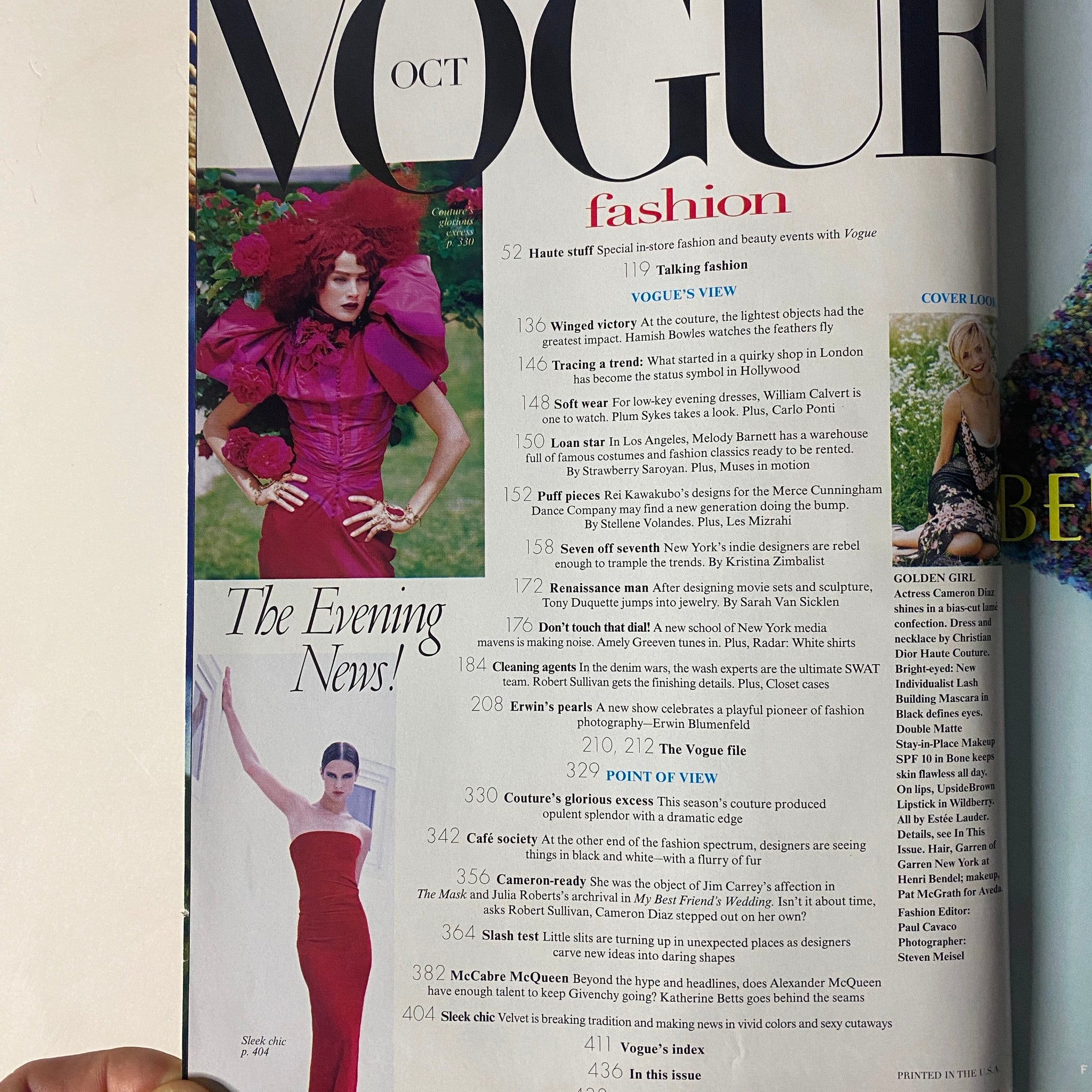 Vogue Magazine October 1997 featuring a striking fashion layout showcasing dramatic couture styles. The page includes detailed articles about fashion events, including coverage of haute couture by designers.