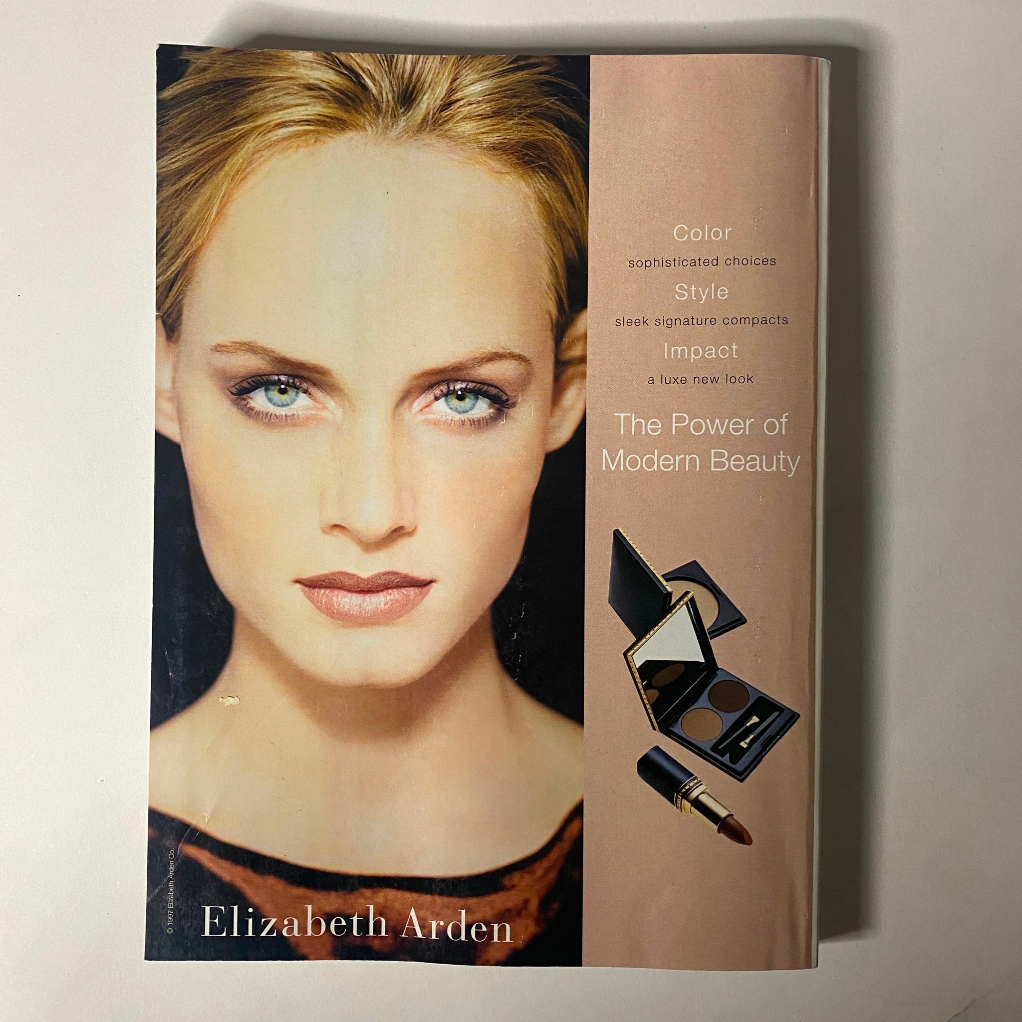 Vogue Magazine October 1997 advertisement for Elizabeth Arden, highlighting modern beauty products with a focus on sophisticated makeup choices. The layout promotes the brand's innovative approach to beauty and style.