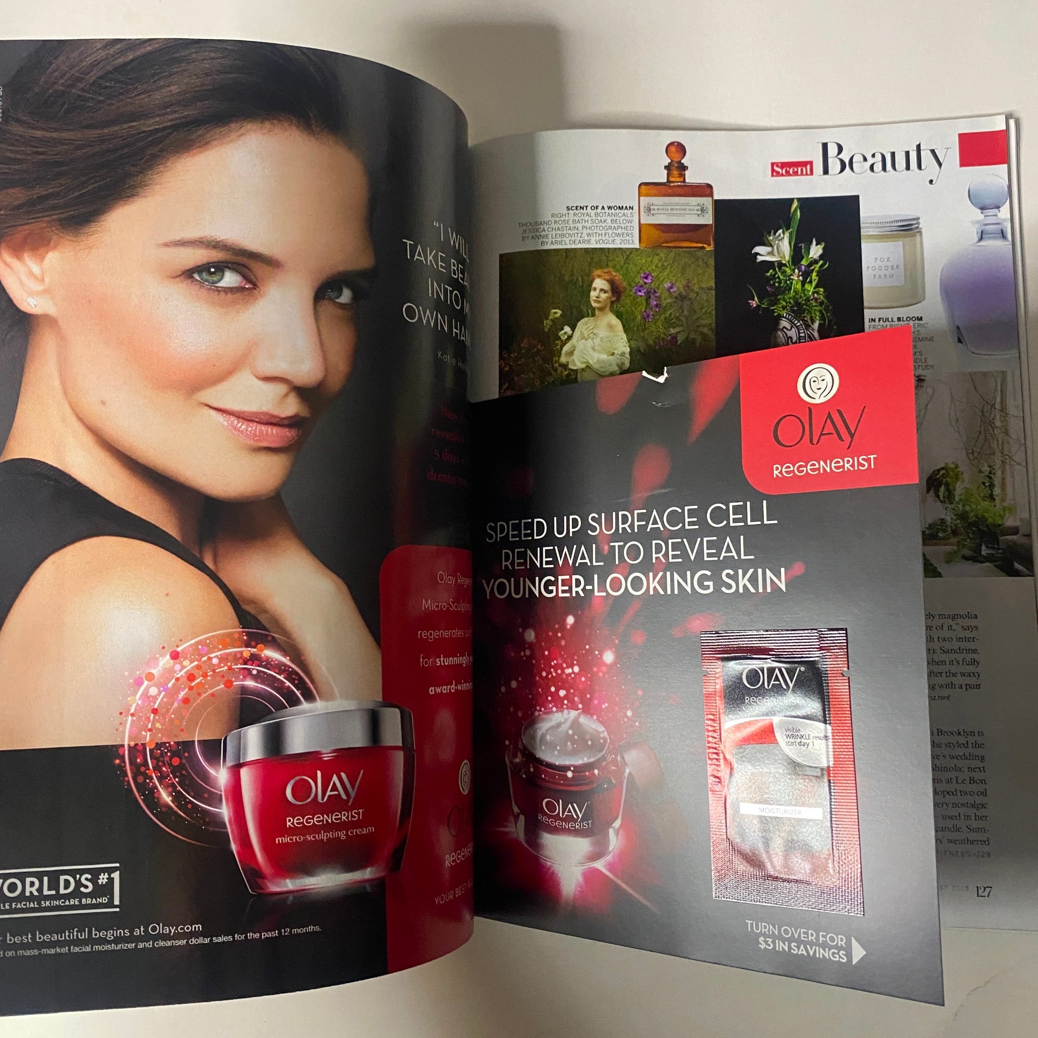 An advertisement featuring Olay Regenerist skincare products from Vogue Magazine August 2015 with Nicole Kidman on the cover. The image showcases a glamorous model promoting youthful skin with bold makeup.