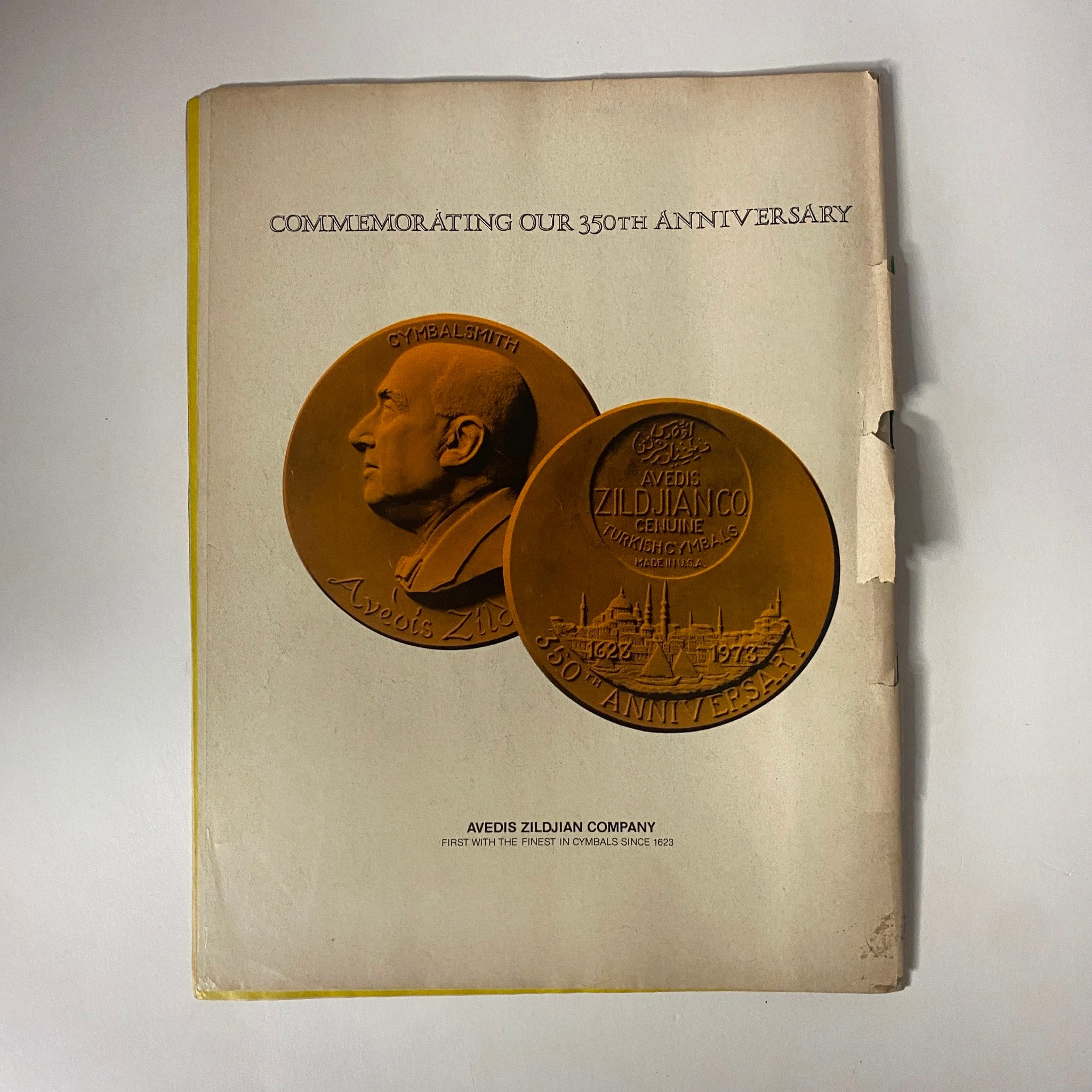 Cover page commemorating the 350th anniversary of Avedis Zildjian Company, featuring the medals on display, related to cymbals.