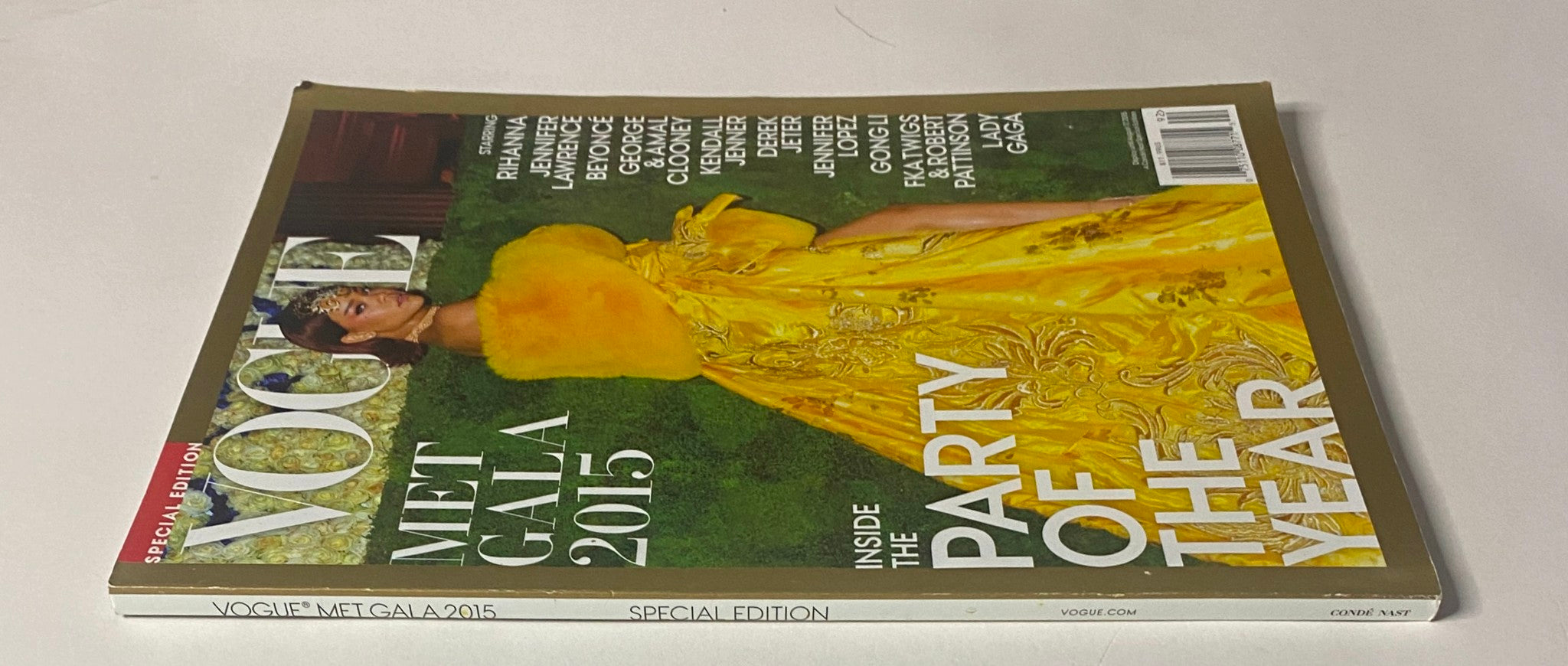 Vogue Magazine 2015 Met Gala cover showcasing Rihanna in a vibrant yellow dress, emphasizing the exclusive party of the year with highlighted guest stars.