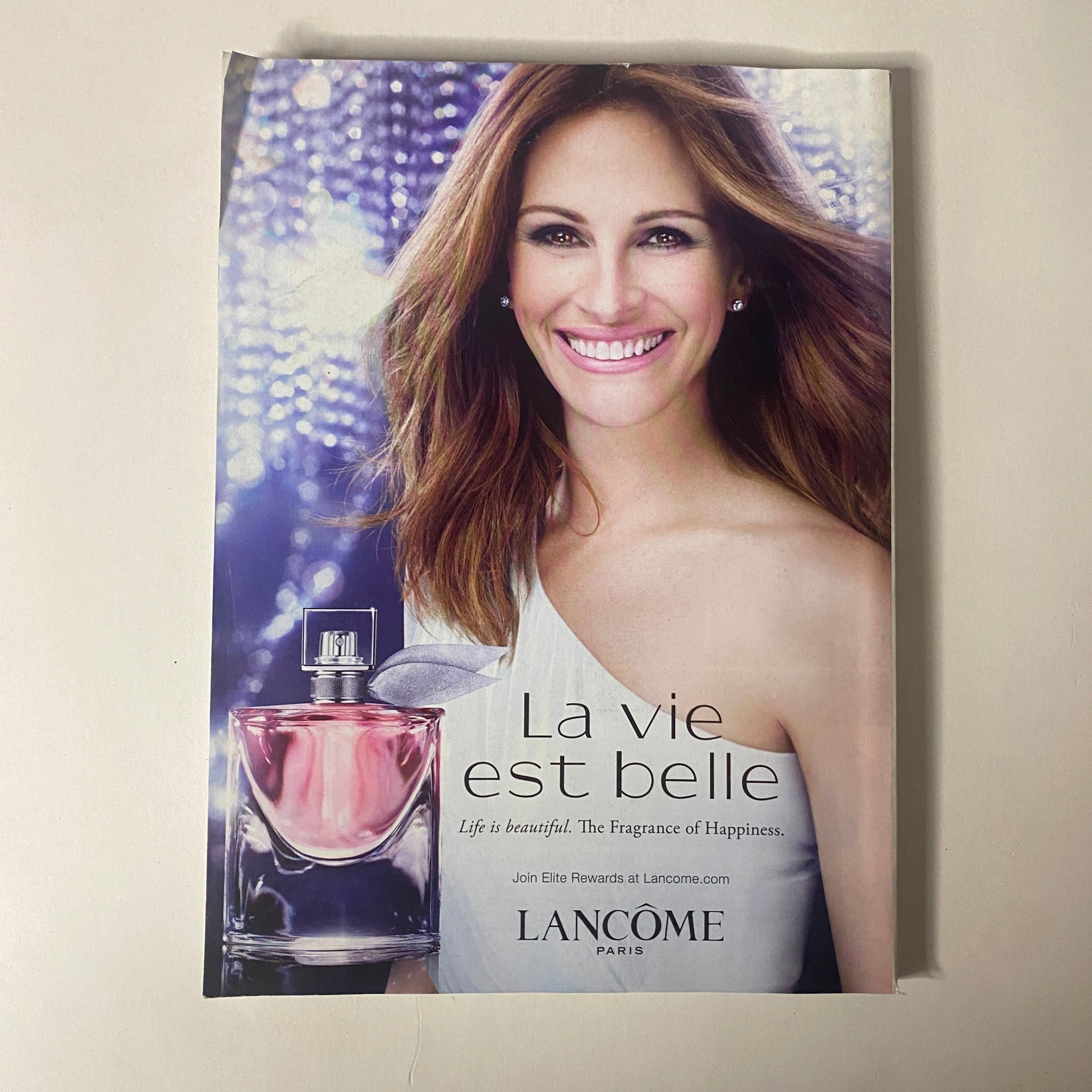Vogue Magazine October 2015 Lupita Nyong'o Cover highlighting a Lancome advertisement with Julia Roberts promoting the fragrance 'La Vie est Belle,' emphasizing beauty and elegance.