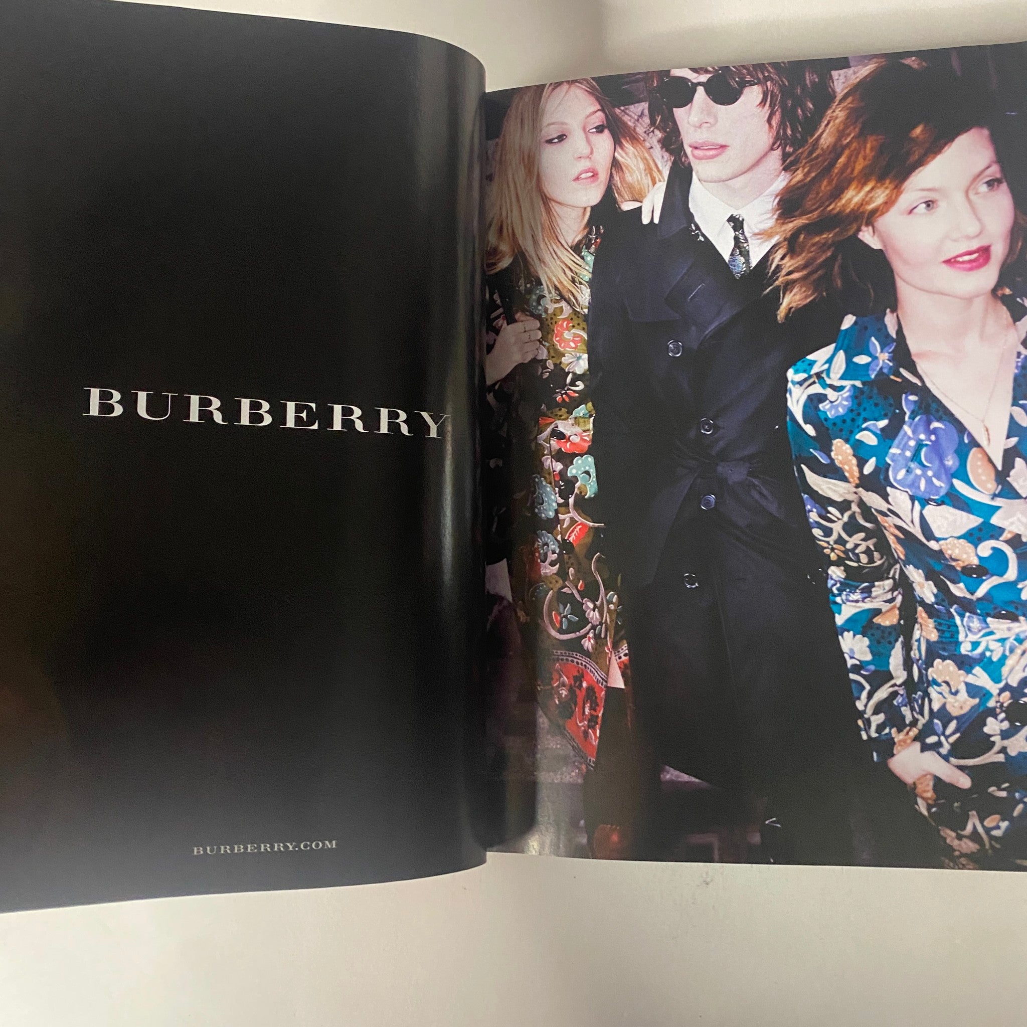 Vogue Magazine September 2015 features a stylish ad for Burberry, capturing a group of models dressed in vibrant floral patterns, reflecting contemporary fashion trends.