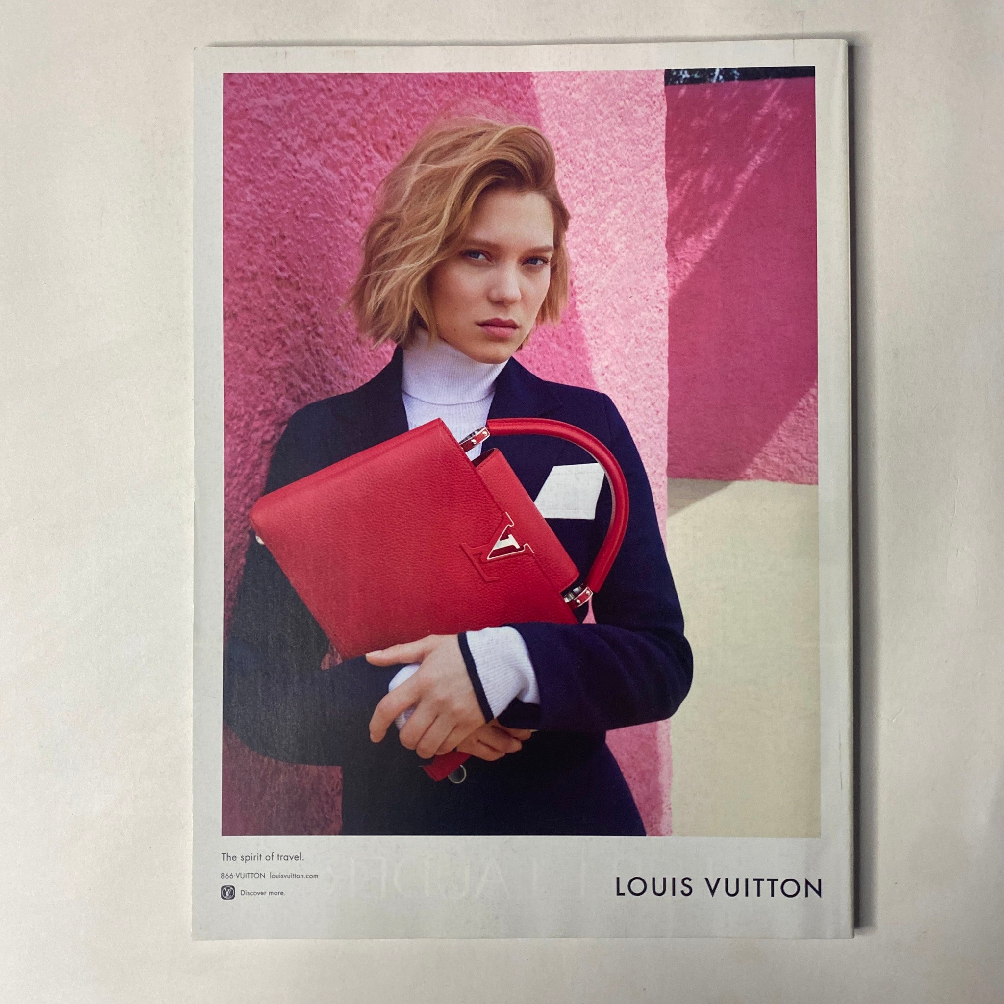 Louis Vuitton advertisement featuring a model holding a red handbag, promoting sophistication and luxury. Related to Vogue Magazine July 2016 Amy Schumer Cover No Label VG.