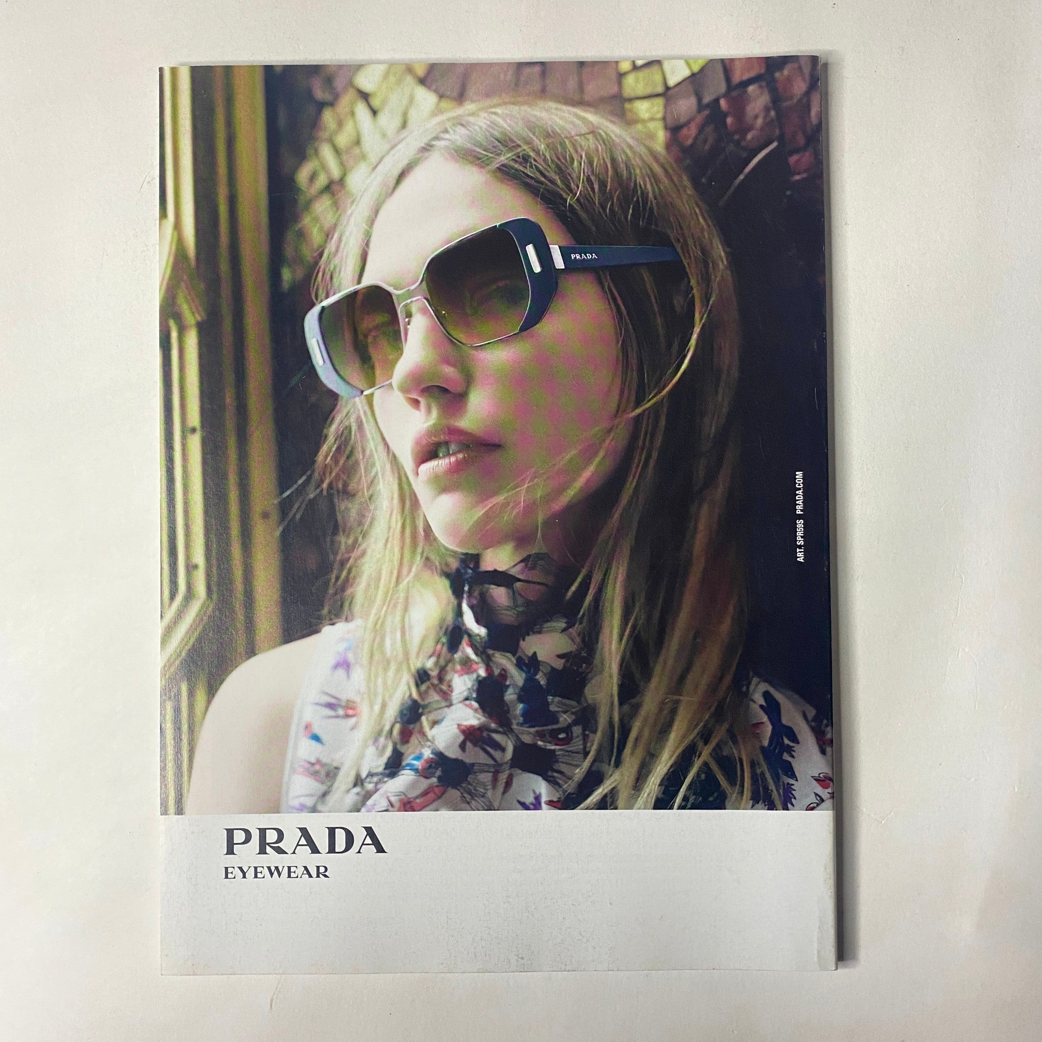 Vogue Magazine June 2016 Margot Robbie Cover includes a vibrant photograph of a woman modeling Prada eyewear, highlighting contemporary fashion in a summer setting.