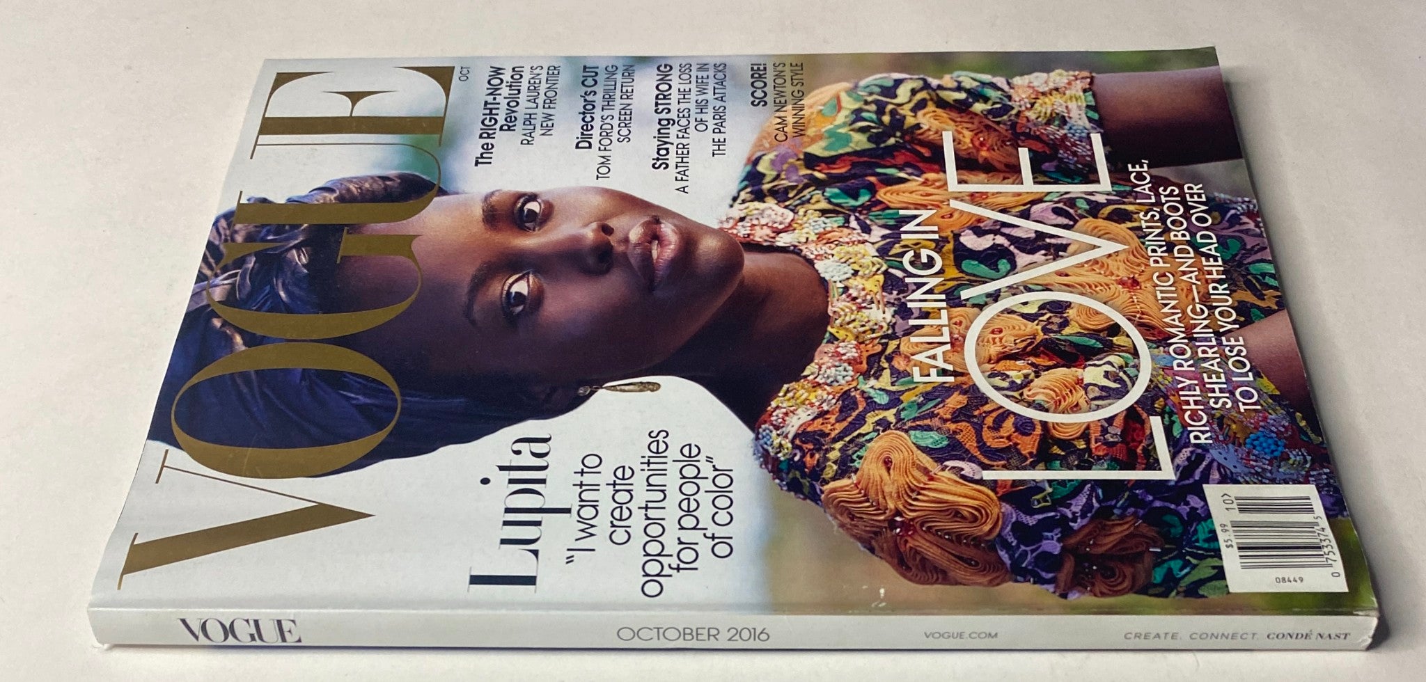 Side view of Vogue Magazine October 2016 showcasing Lupita Nyong'o on the cover, adorned in colorful attire, emphasizing the theme 'FALLING IN LOVE' and her advocacy for diversity in fashion.