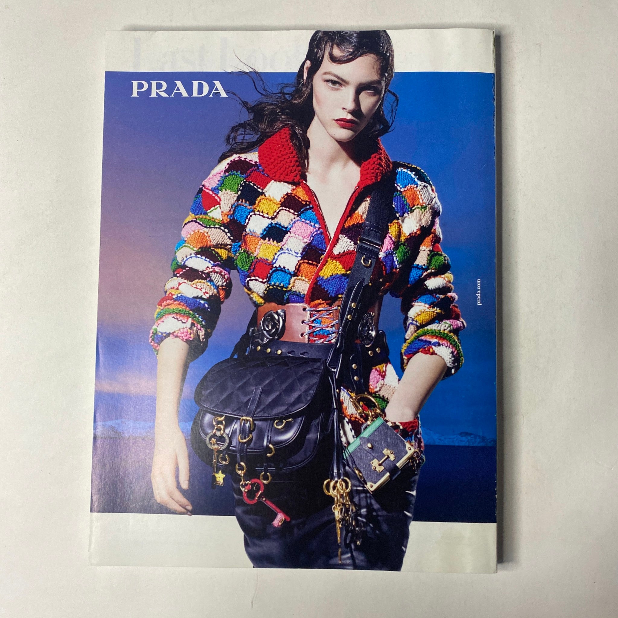 Fashion editorial featuring a model in a colorful knitted jacket, promoting Prada, alongside the Vogue Magazine October 2016 Lupita Nyong'o Cover No Label VG.