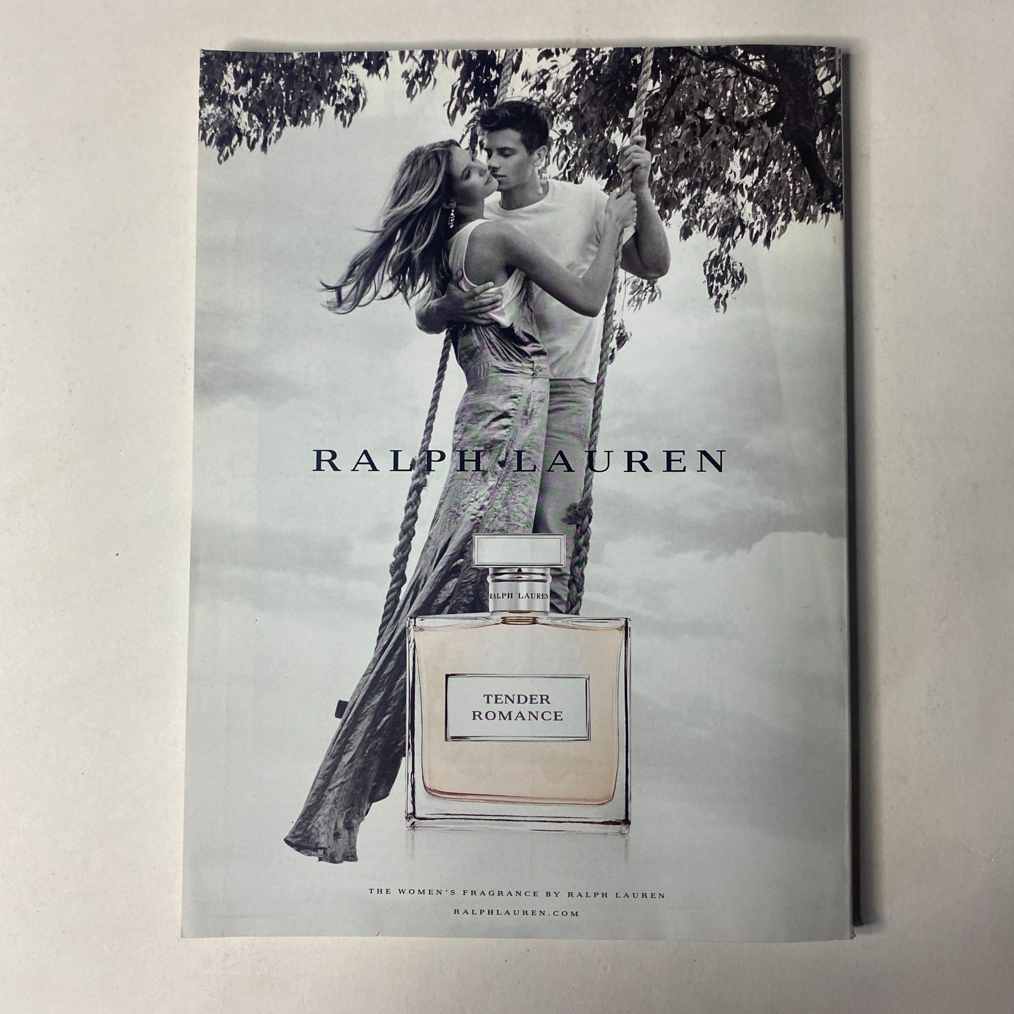 Ralph Lauren Tender Romance fragrance advertisement showing a couple in an embrace on a swing, promoting romance and elegance. This is associated with the Vogue Magazine November 2016 Emma Stone Cover No Label VG.