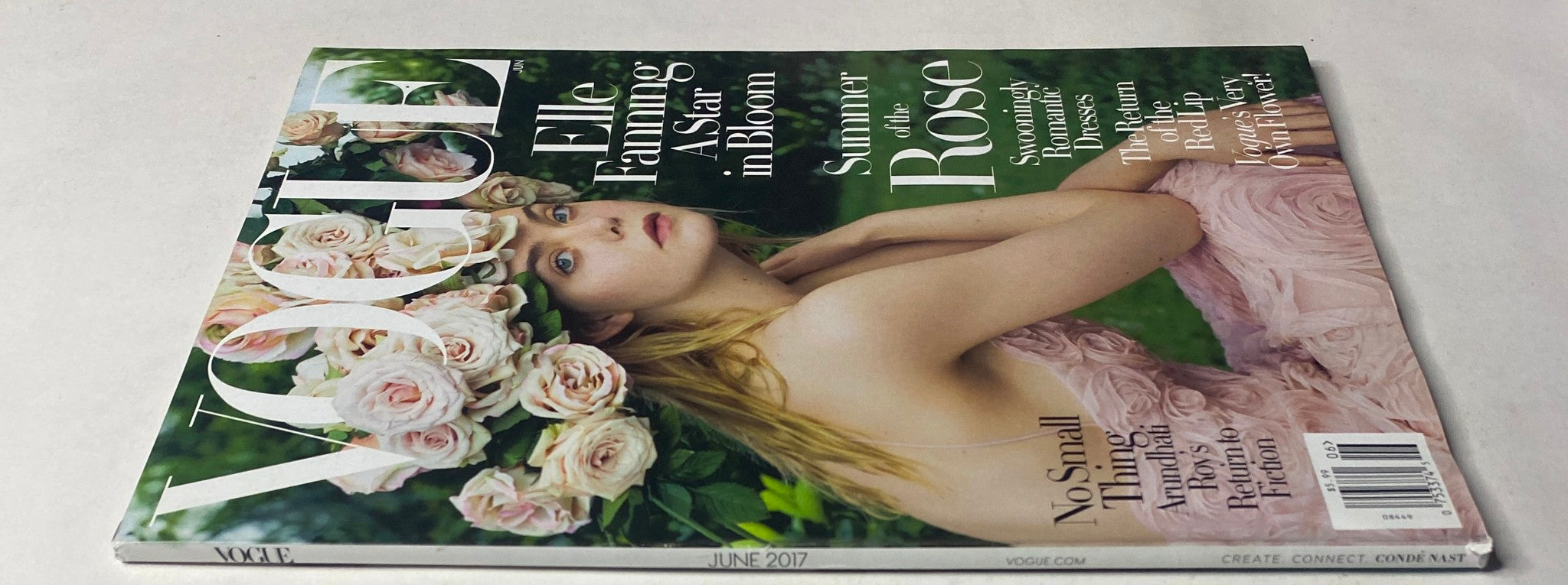 Side view of Vogue Magazine June 2017 with Elle Fanning on the cover, showcasing her elegance and the romantic summer theme, 'Summer of the Rose'.