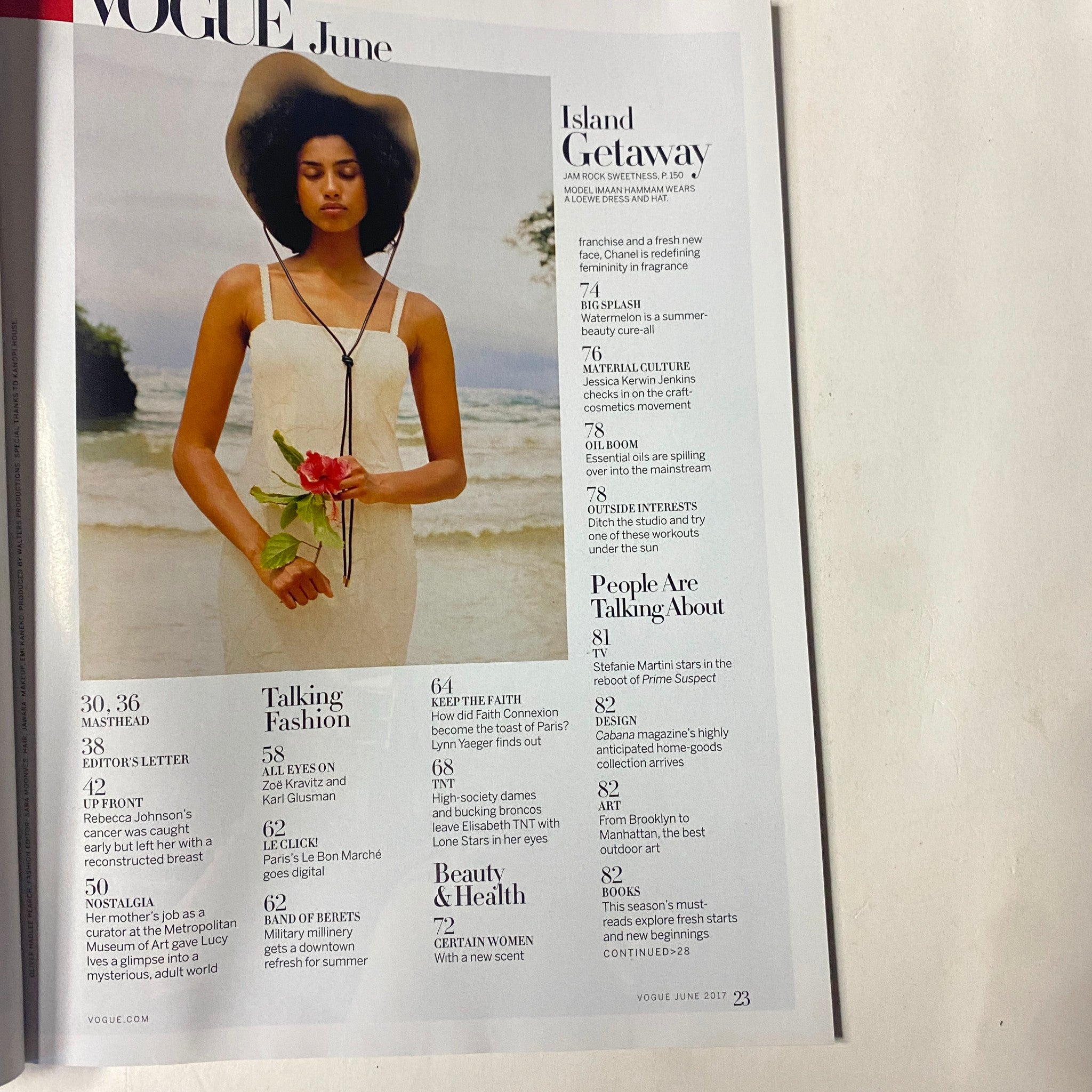 Table of contents page from Vogue Magazine June 2017 featuring various articles including 'Island Getaway' and 'Talking Fashion.' Highlights Elle Fanning's cover story.
