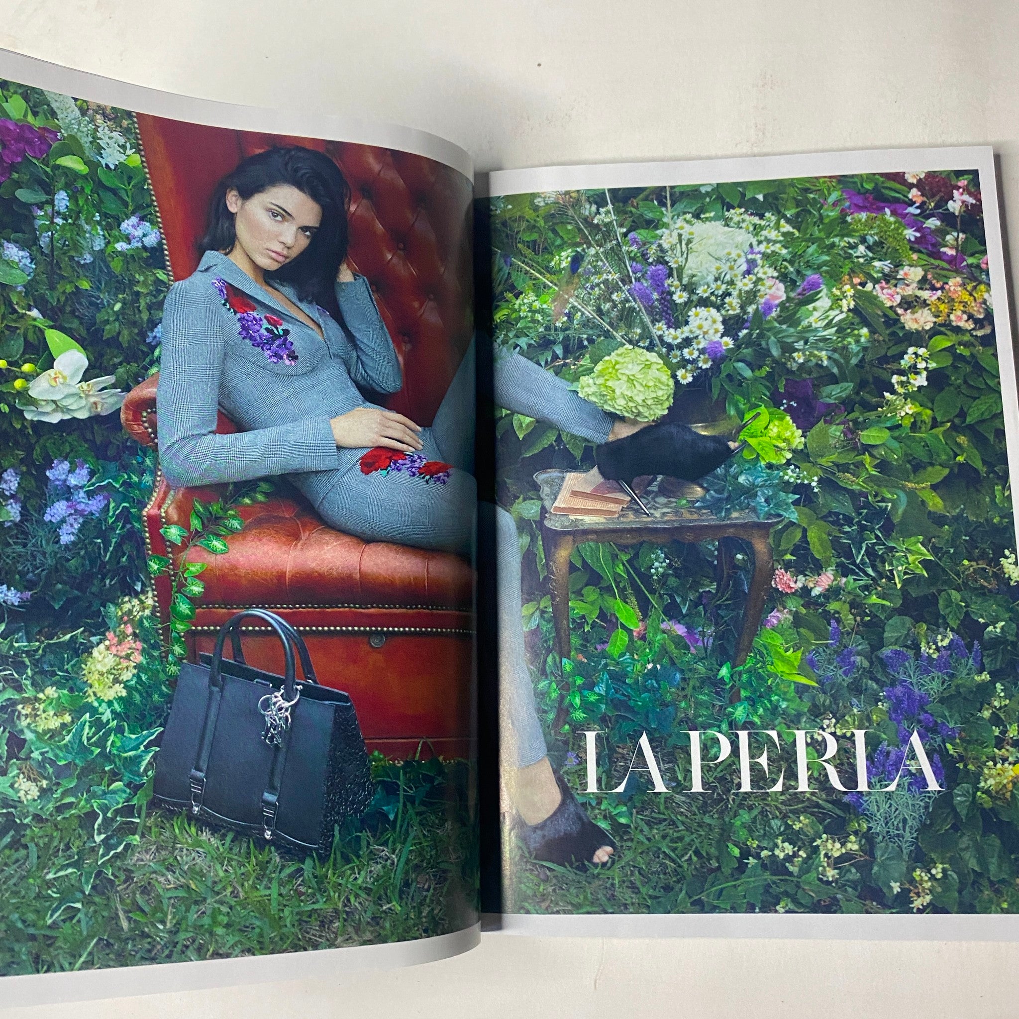 Fashion advertisement in Vogue Magazine October 2017 featuring a model in a stylish outfit among a floral backdrop, showcasing La Perla collection.