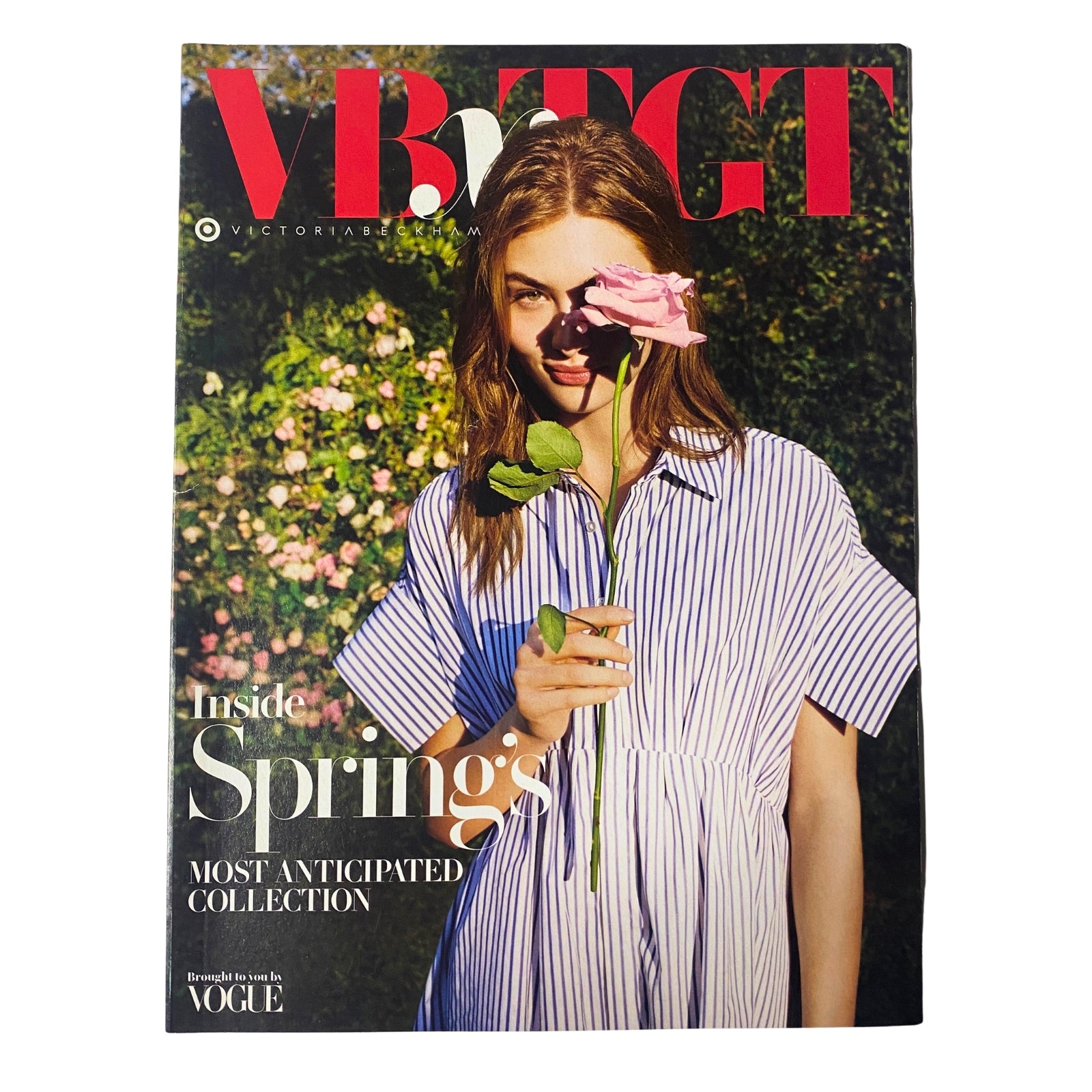 Cover of Vogue Magazine featuring Victoria Beckham's Spring Collection, showcasing a model holding a flower with a stylish striped dress. Title: Vogue Magazine Victoria Beckham Spring Collection No Label VG.