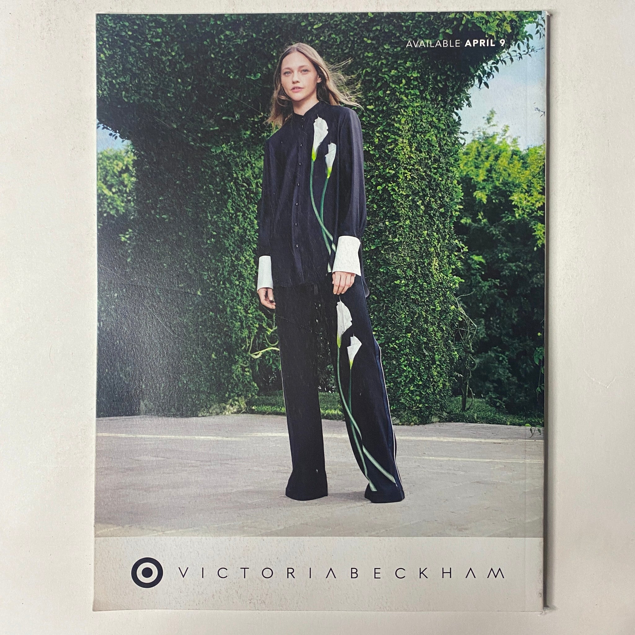 Cover of Vogue Magazine featuring Victoria Beckham's Spring Collection, showcasing a model in a stylish outfit with floral detailing, available April 2023.