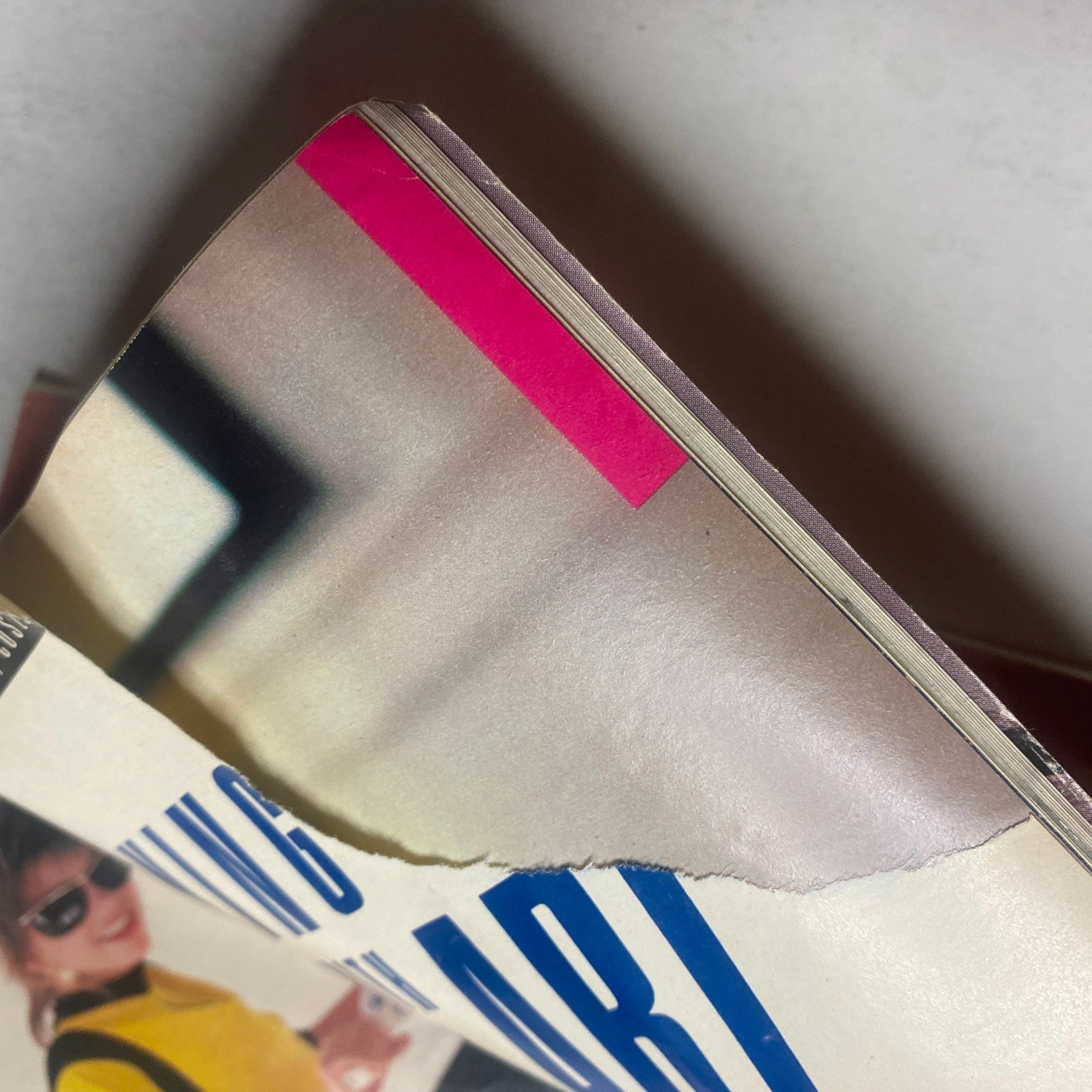Close-up of damage on Seventeen Magazine July 1985, indicating a small tear, highlighting the condition of this vintage magazine featuring Joan Collins and John Taylor.