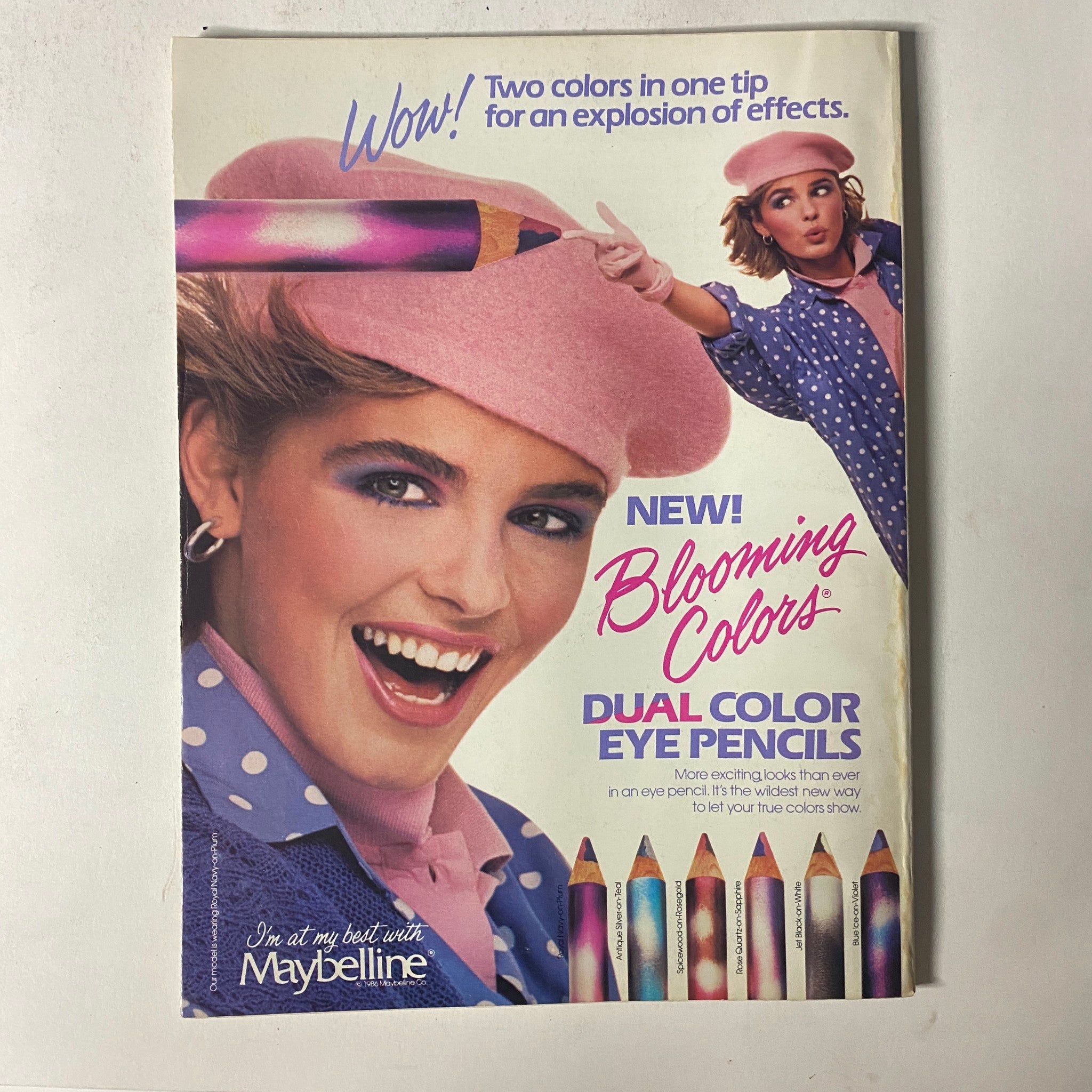Ad from Seventeen Magazine December 1986 promoting Maybelline's Blooming Colors dual color eye pencils, emphasizing fun and vibrant makeup options.