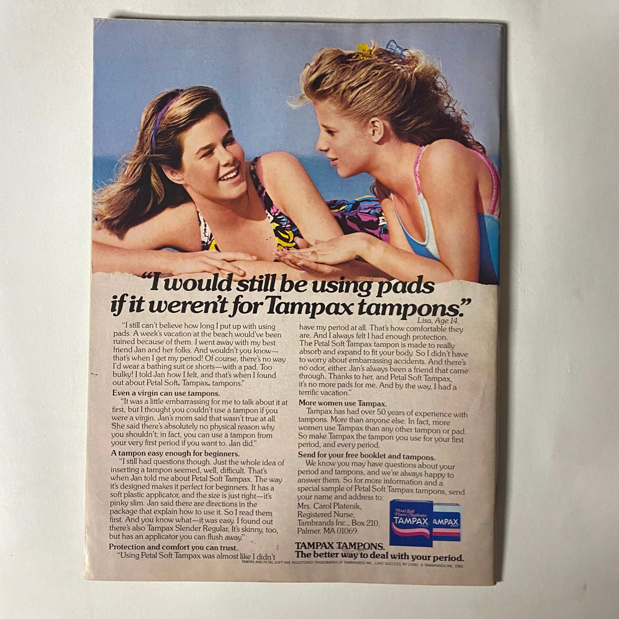 Back cover of Teen Magazine November 1986 featuring an advertisement for Tampax tampons with an image of two women on the beach discussing product benefits.