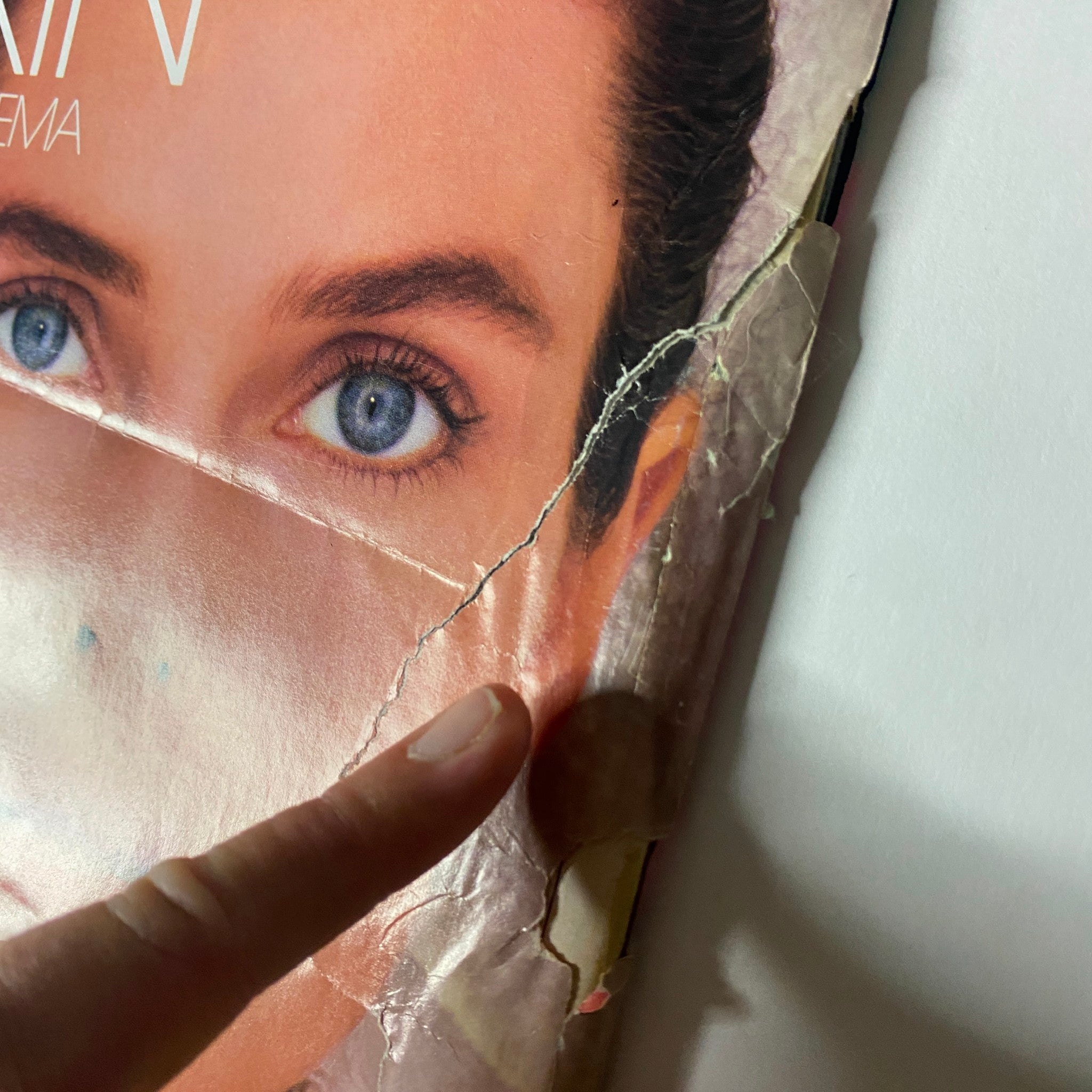 Detailed view of the Noxzema skincare ad from Teen Magazine May 1987, focusing on a model's eyes and facial features, highlighting damage with prominent tears and marks.