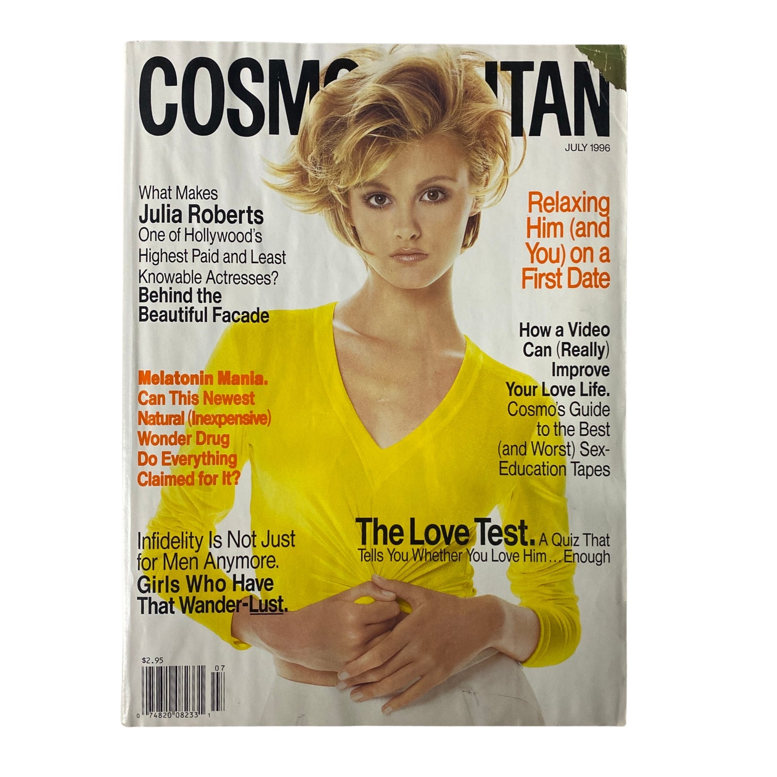 Cover of Cosmopolitan Magazine July 1996 featuring Julia Roberts, showcasing her timeless appeal in a bright yellow top, with a focus on relationship advice and beauty tips.