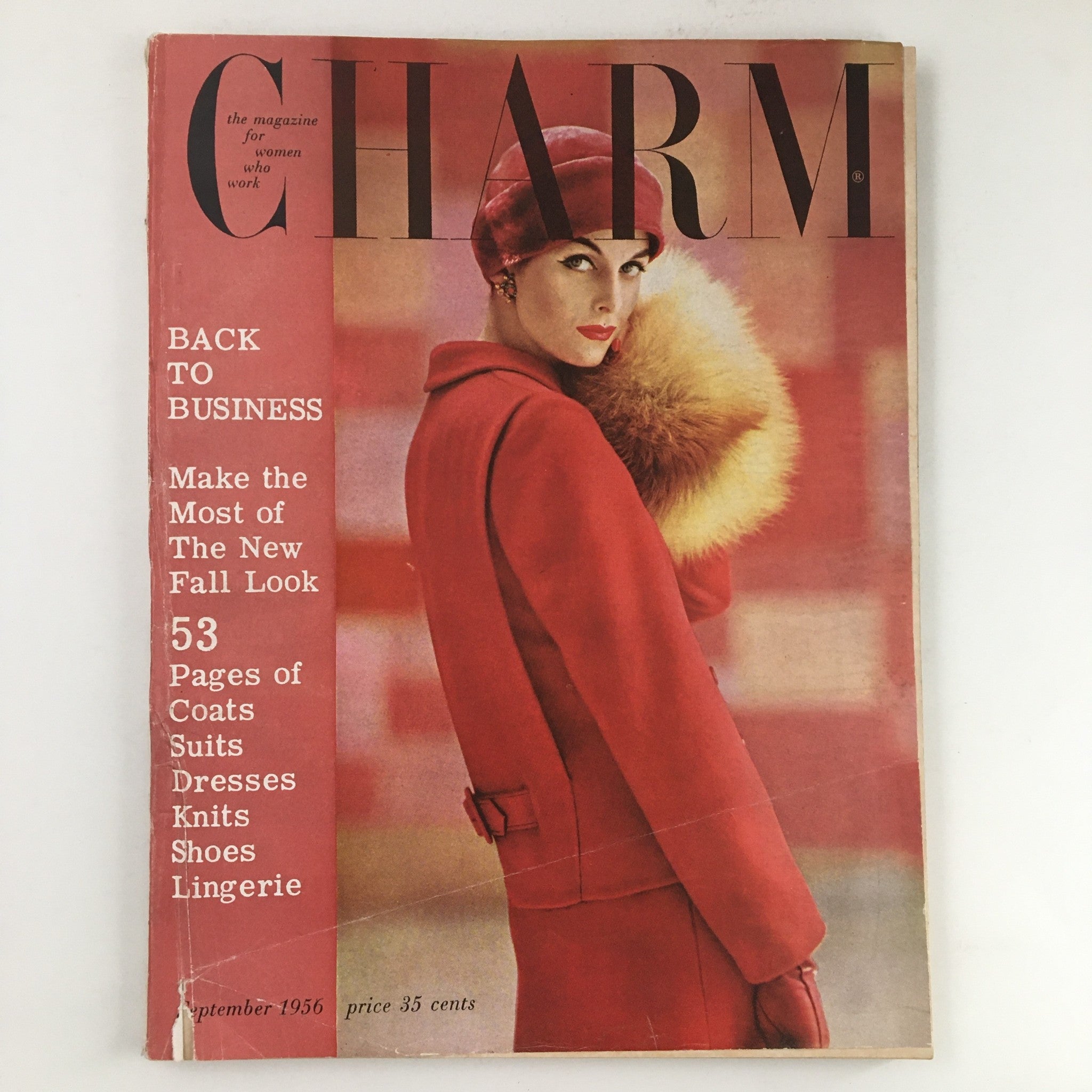 Cover of Charm Magazine September 1956 featuring a woman in a stylish red coat and hat, showcasing fall fashion trends of the era with the headline 'Make The Most of The New Fall Look'.