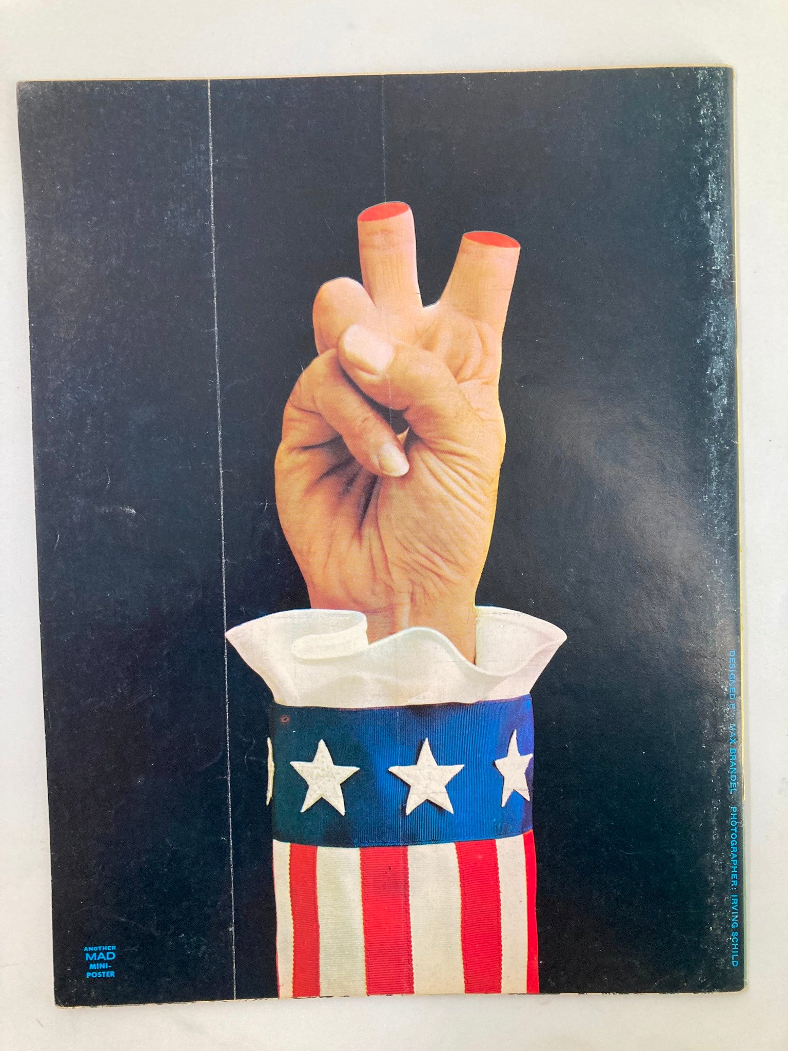 Cover image of Mad Magazine April 1973 No. 158 featuring a hand with fingers in a peace sign, dressed in an Uncle Sam-inspired sleeve with red, white, and blue design.