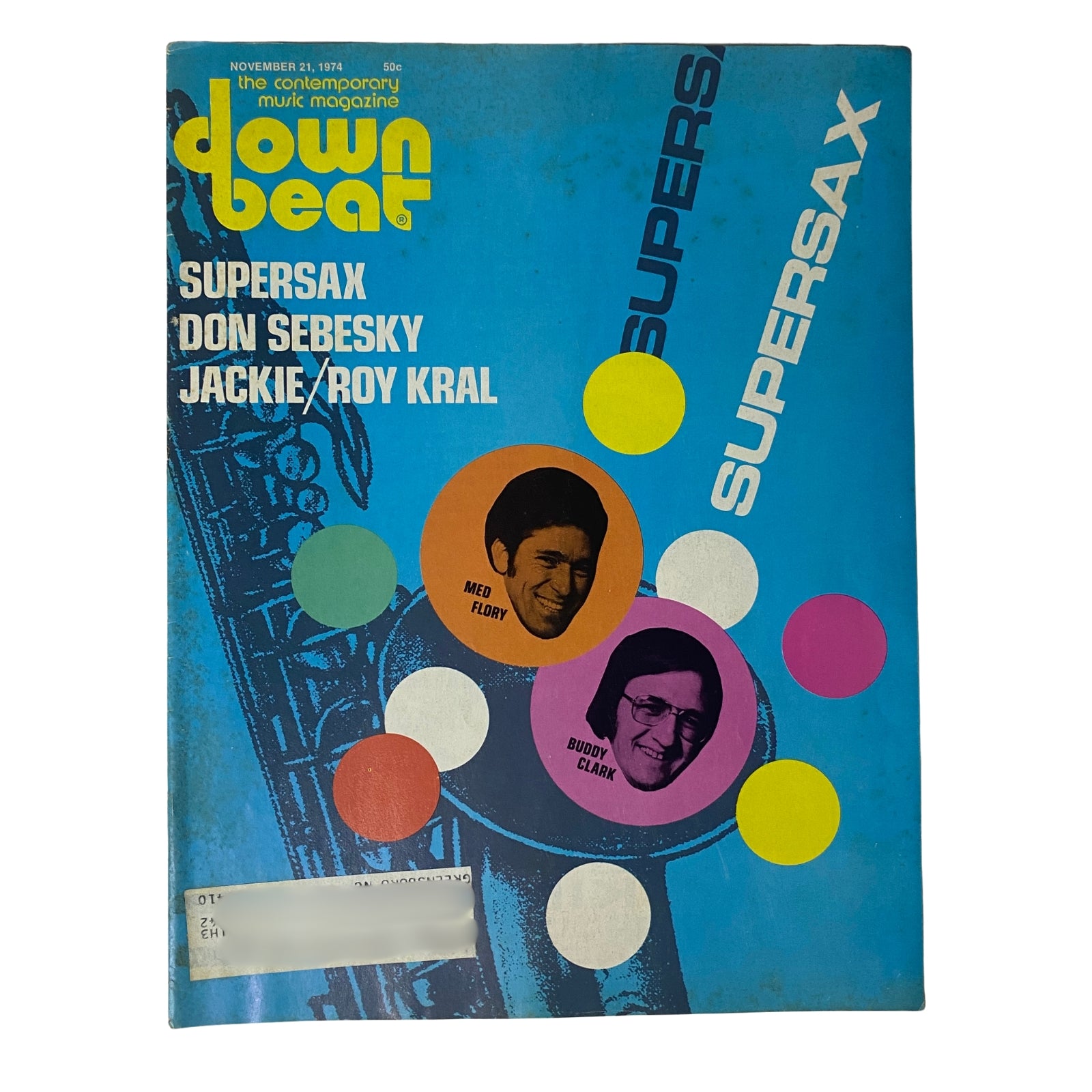 Down Beat Magazine cover from November 21, 1974, Vol 41 No. 19 featuring Supersax, Don Sebesky, Jackie, and Roy Kral. The cover design includes colorful circles on a blue background, showcasing prominent jazz musicians Med Flory and Buddy Clark.