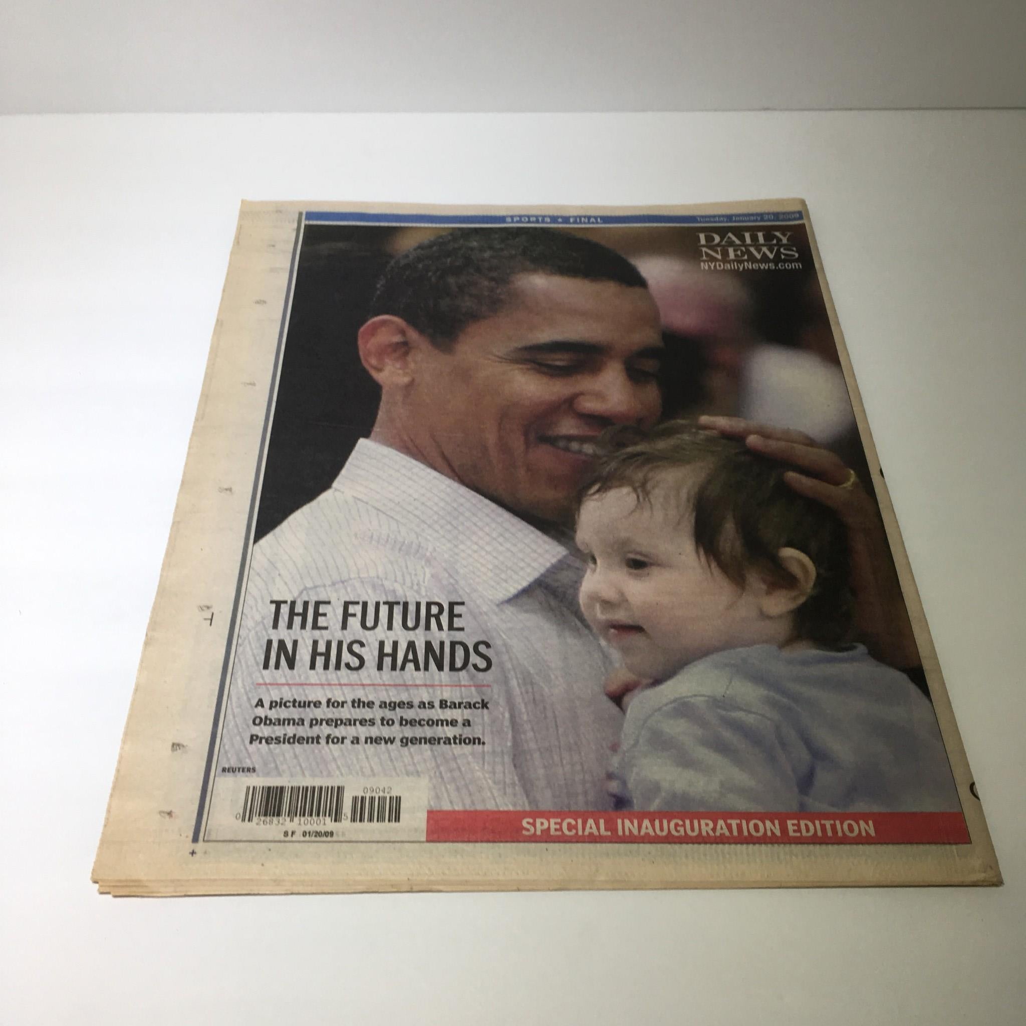NY Daily News cover featuring a touching image of Barack Obama holding a child, symbolizing hope and future leadership, from January 20, 2009.