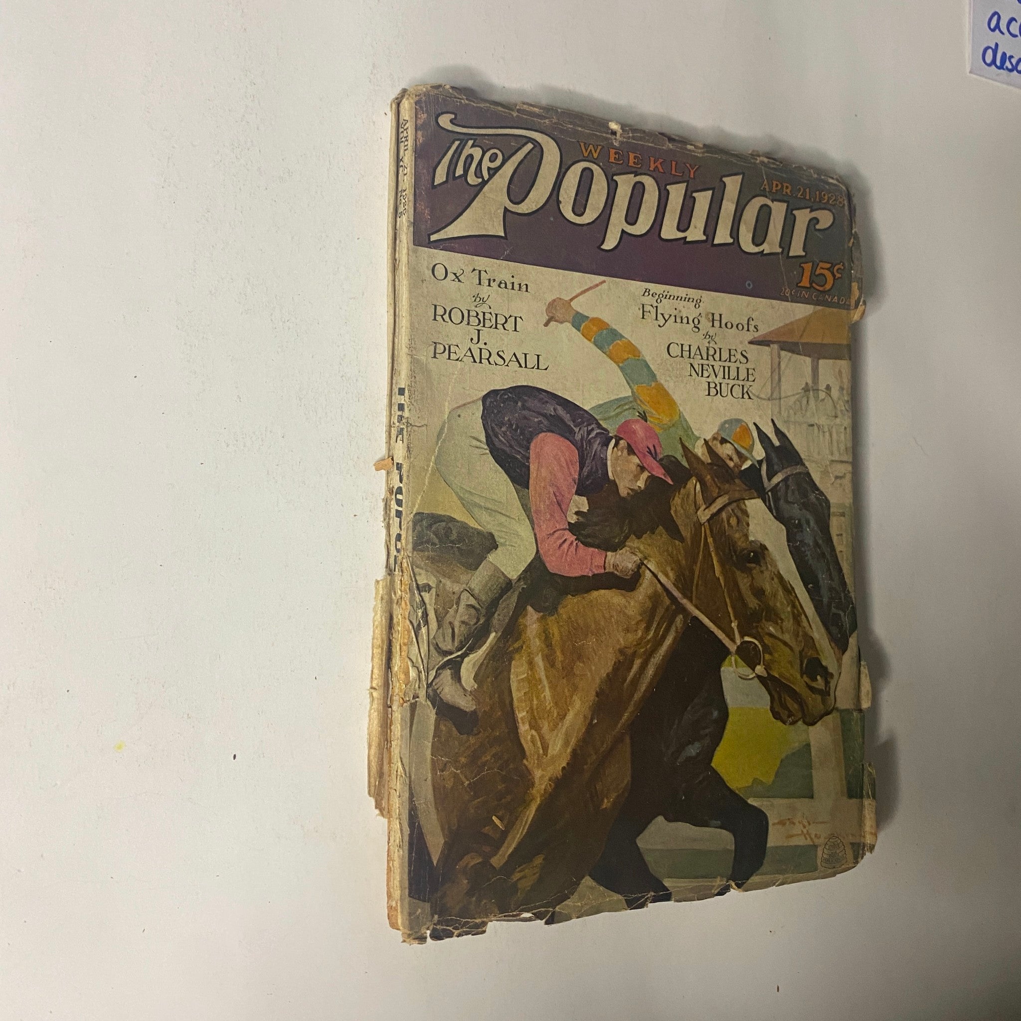 Another view of the cover of The Popular Magazine from April 21, 1928 illustrating 'Ox Train' and 'Flying Hoofs' alongside artwork related to horse racing.