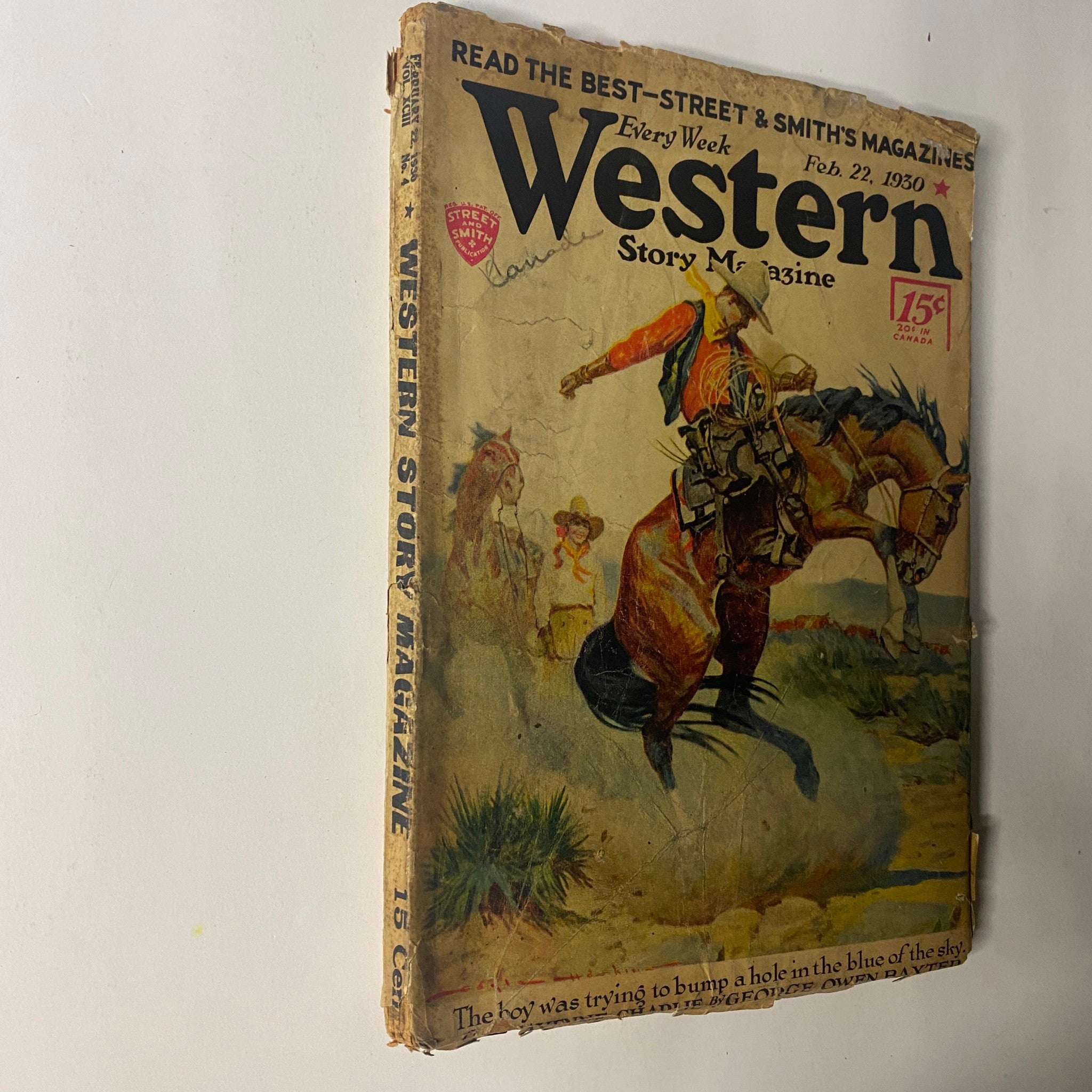 Close-up view of the February 22, 1930 issue of Western Story Magazine, showcasing dynamic artwork with a cowboy on a horse, indicative of classic pulp fiction.