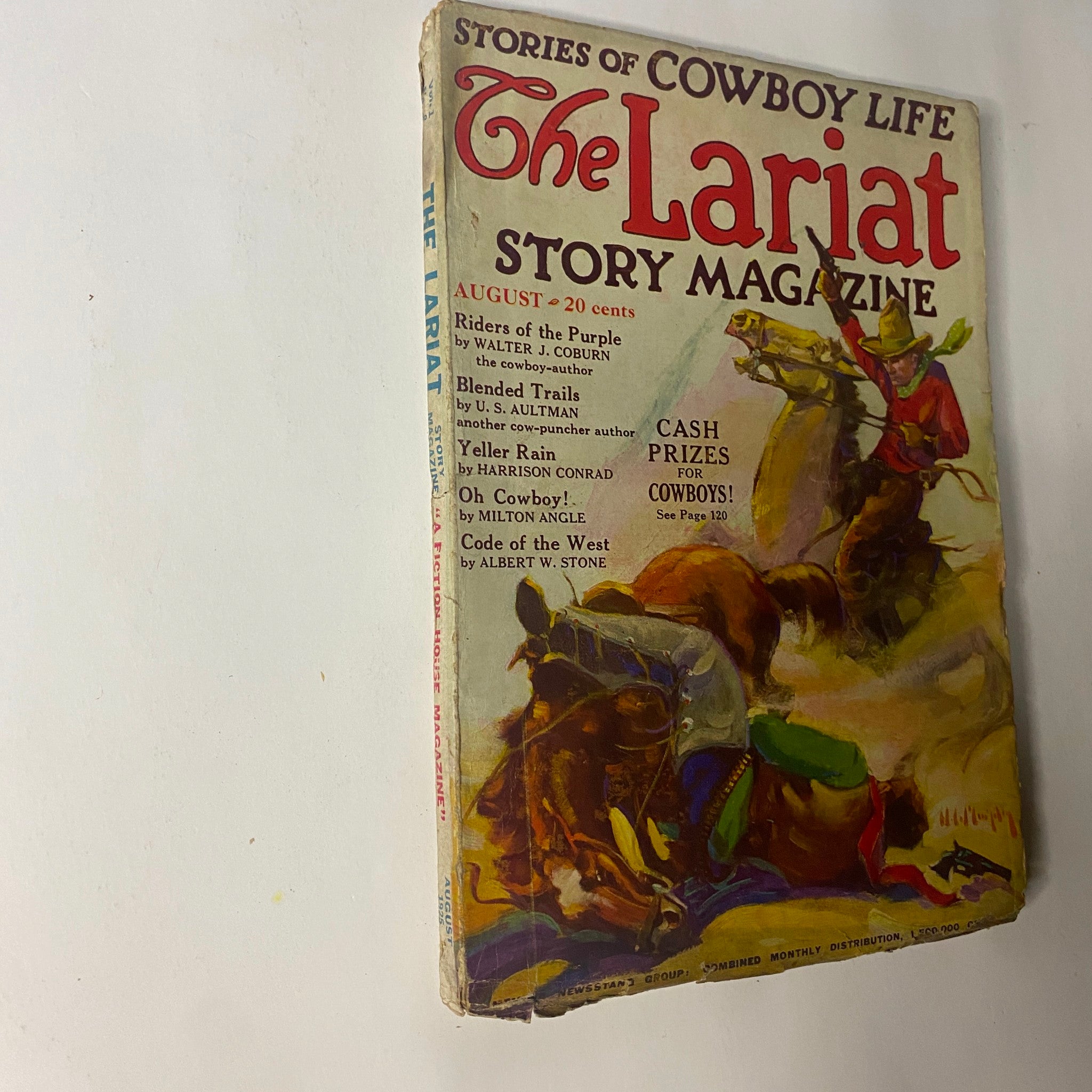  angled view of The Lariat Story Magazine August 1925, emphasizing its colorful cover art related to cowboy culture and adventure.