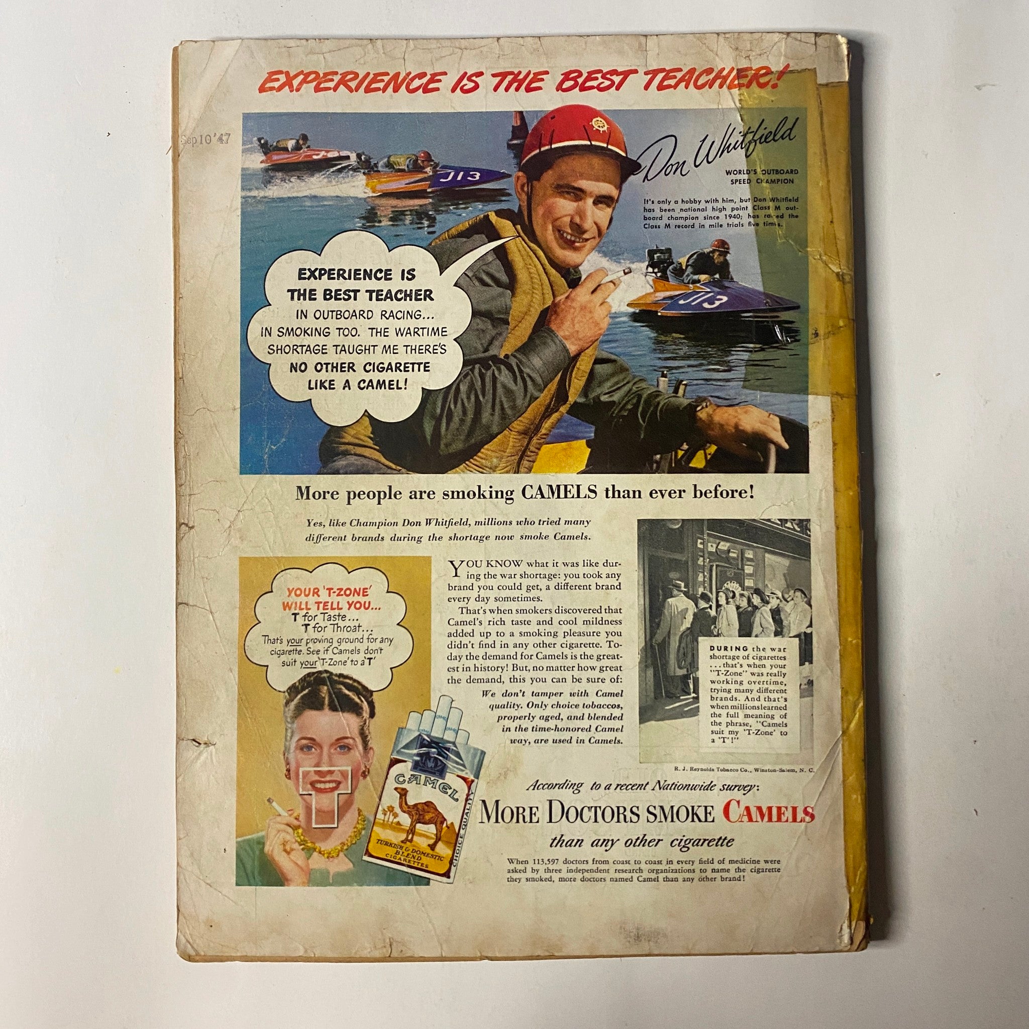 Back cover of Outdoor Life Magazine July 1947 showcasing an advertisement for Camel cigarettes with a striking image of a man in a racing suit.