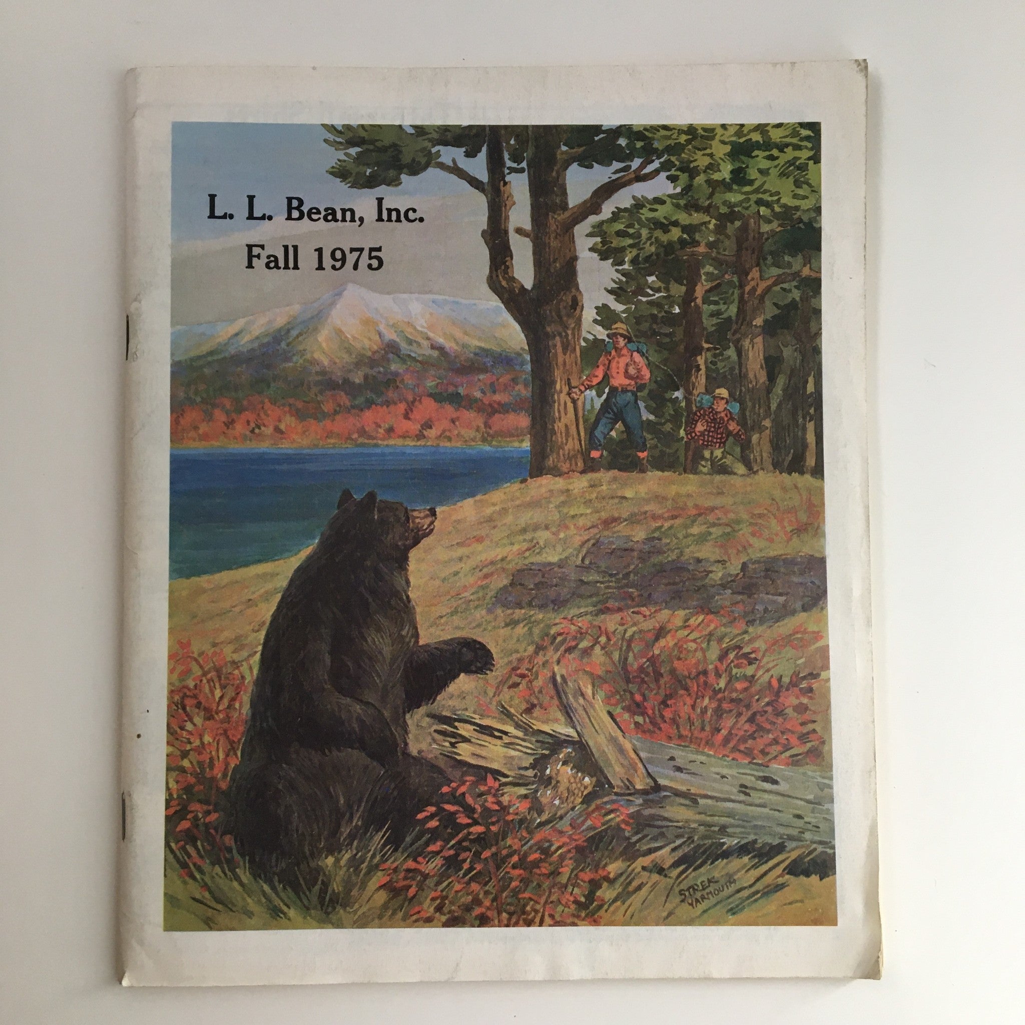 Cover of the 1975 Fall L.L. Bean Retail Company, Inc. Price Guide Catalog featuring a scenic illustration of a bear and outdoor activities, representing vintage outdoor fashion and gear.