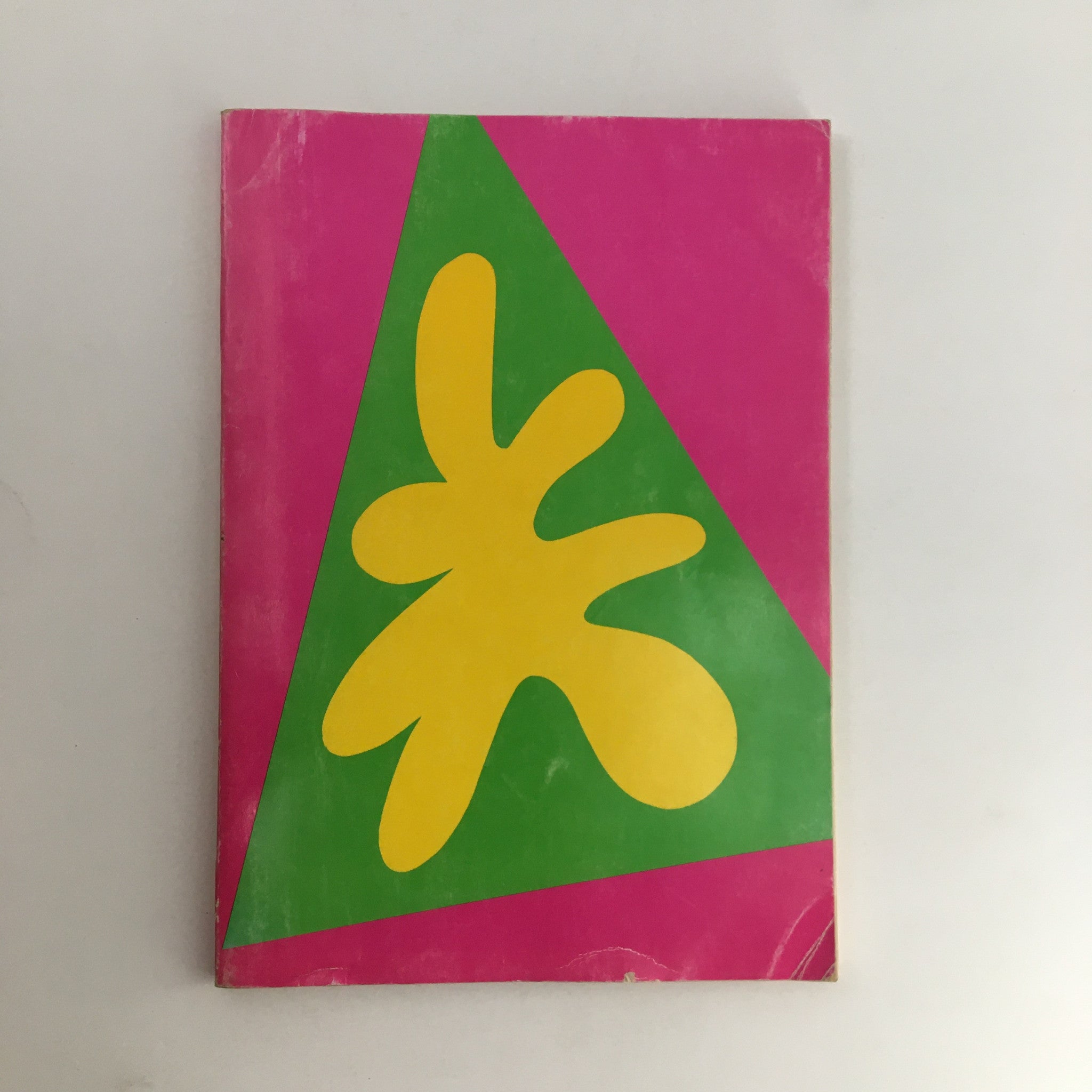 Cover of the 1970 The Lord and Taylor Christmas Book featuring a vibrant pink and green design with a yellow abstract shape, ideal for vintage Christmas collectors.