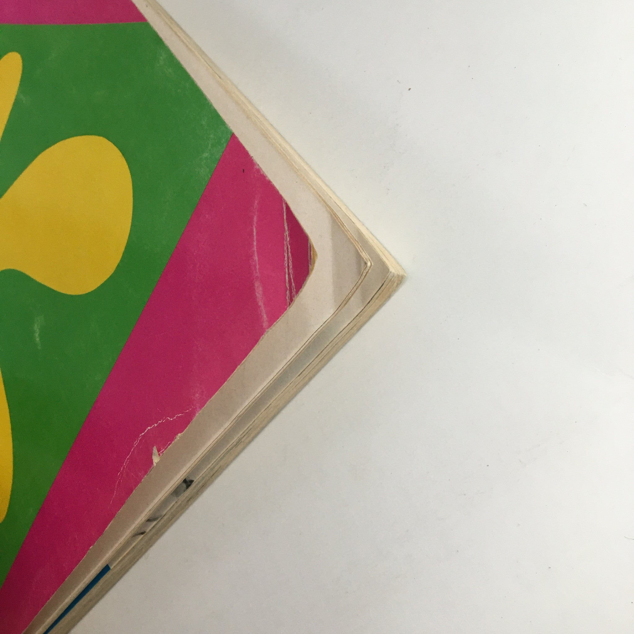 Close-up view of the spine of the 1970 The Lord and Taylor Christmas Book, showcasing slight wear and colorful cover design.