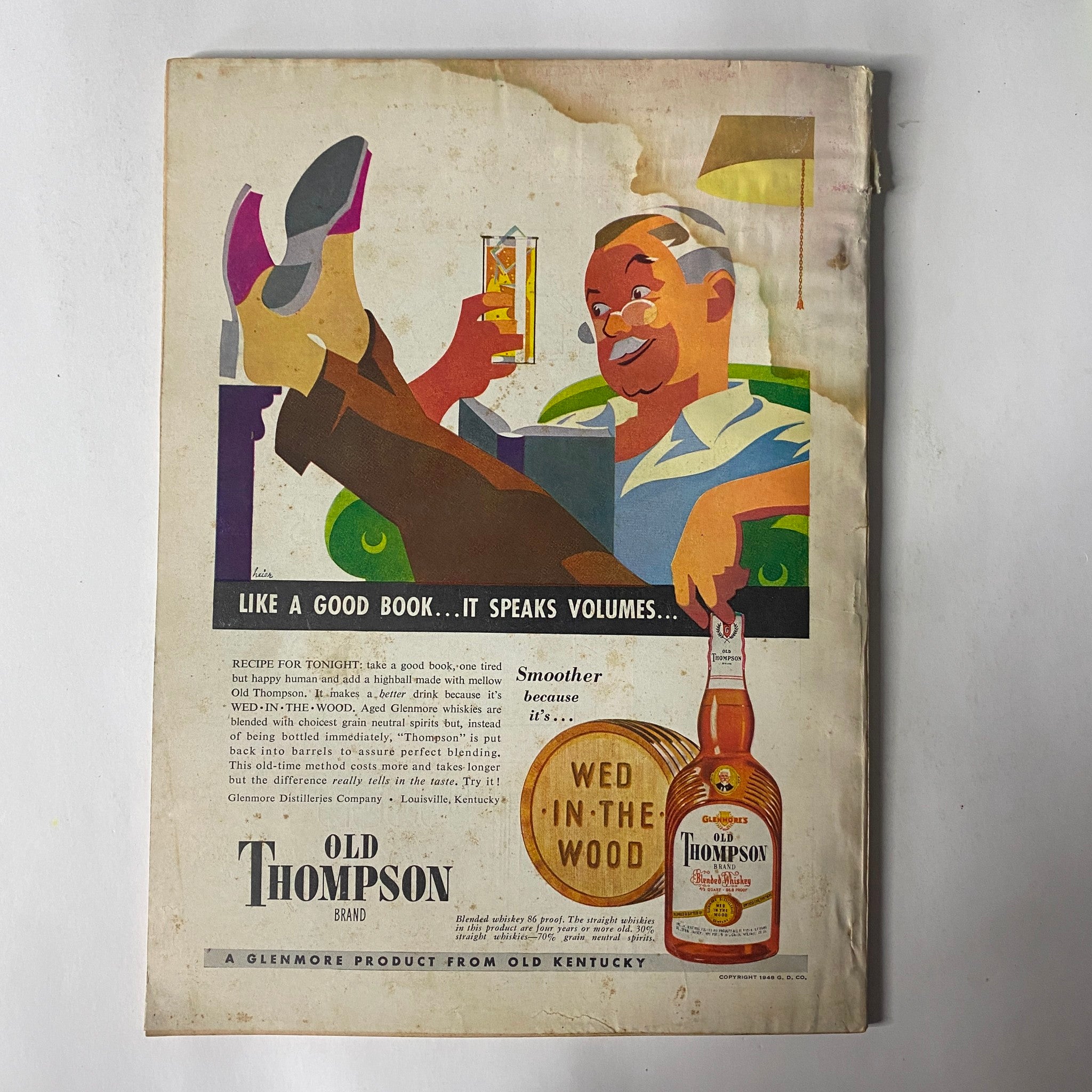 Back cover of 'Outdoor Life Magazine March 1948' showcasing an advertisement for Old Thompson whiskey with an illustration of a relaxed man enjoying a drink.