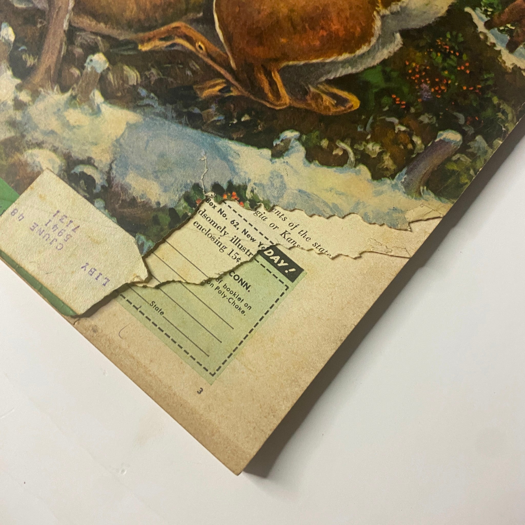 Field & Stream Magazine December 1947 Special Christmas Issue detail image showing the damaged corner of the cover, highlighting vintage magazine characteristics and wear.