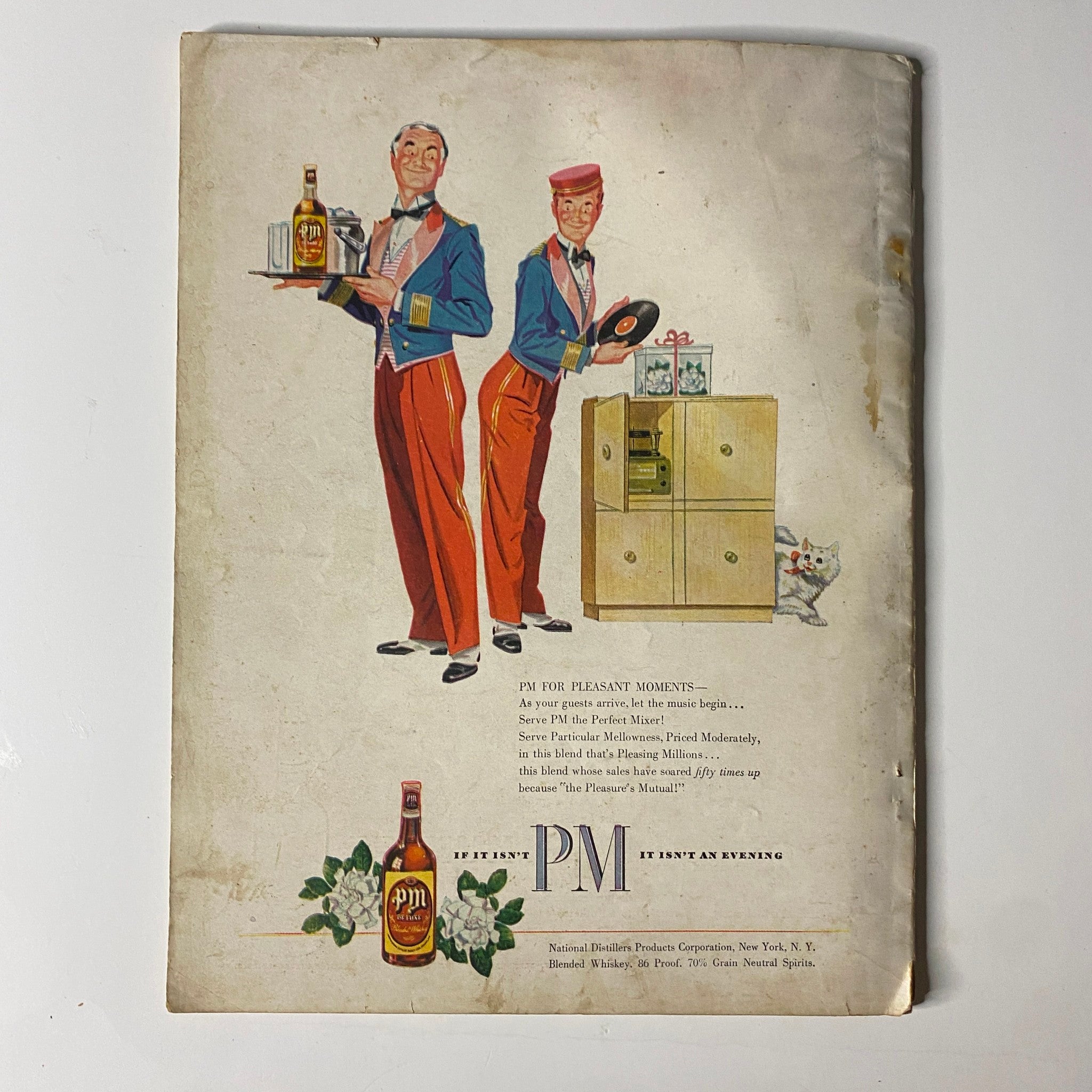 Back cover of True: The Man's Magazine, September 1948 featuring a whimsical illustration of two men in formal attire presenting a drink advertisement with a playful cat.