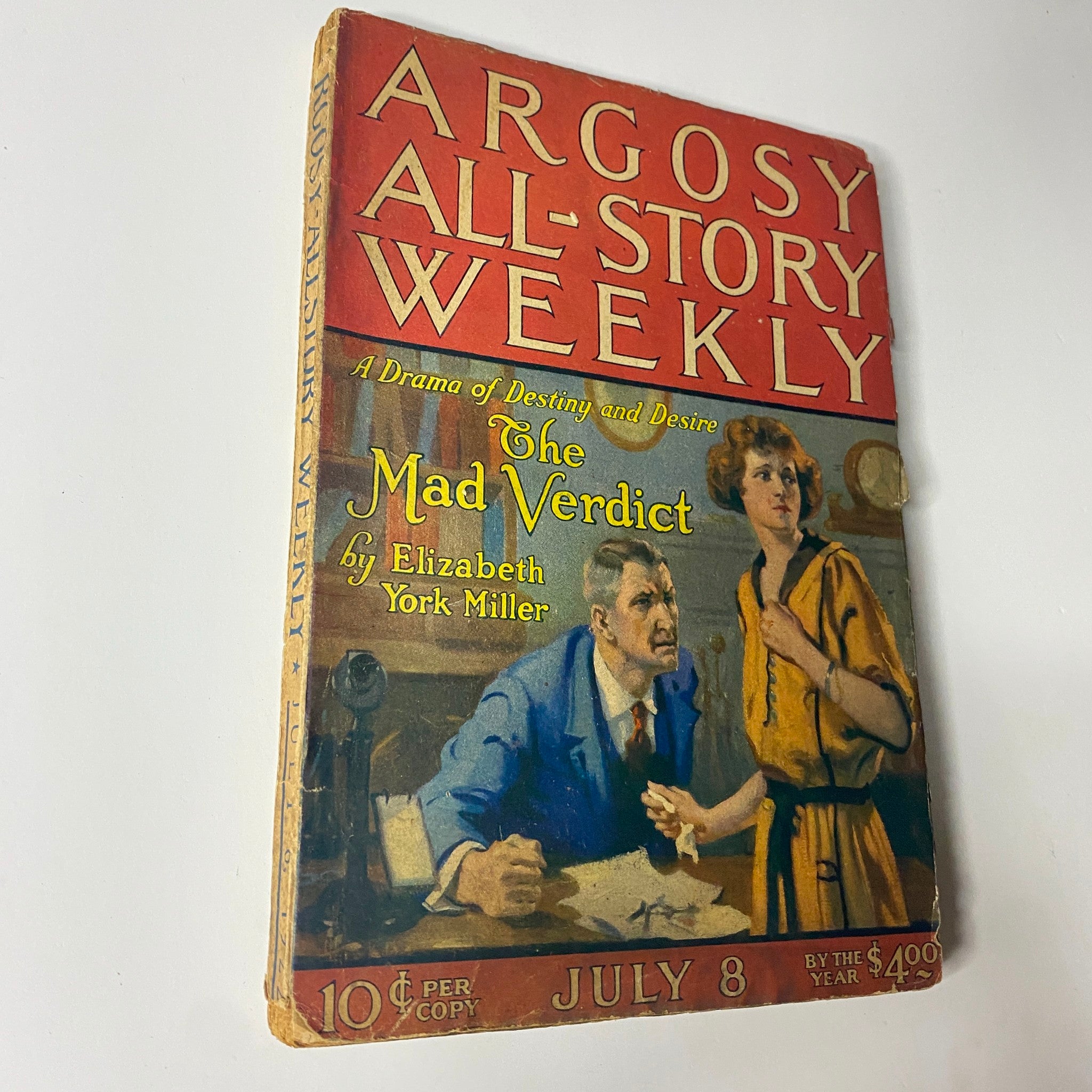 Photograph of the cover of Argosy All-Story Weekly dated July 8, 1922, titled 'The Mad Verdict', showcasing a dramatic scene with characters involved in a tense conversation.