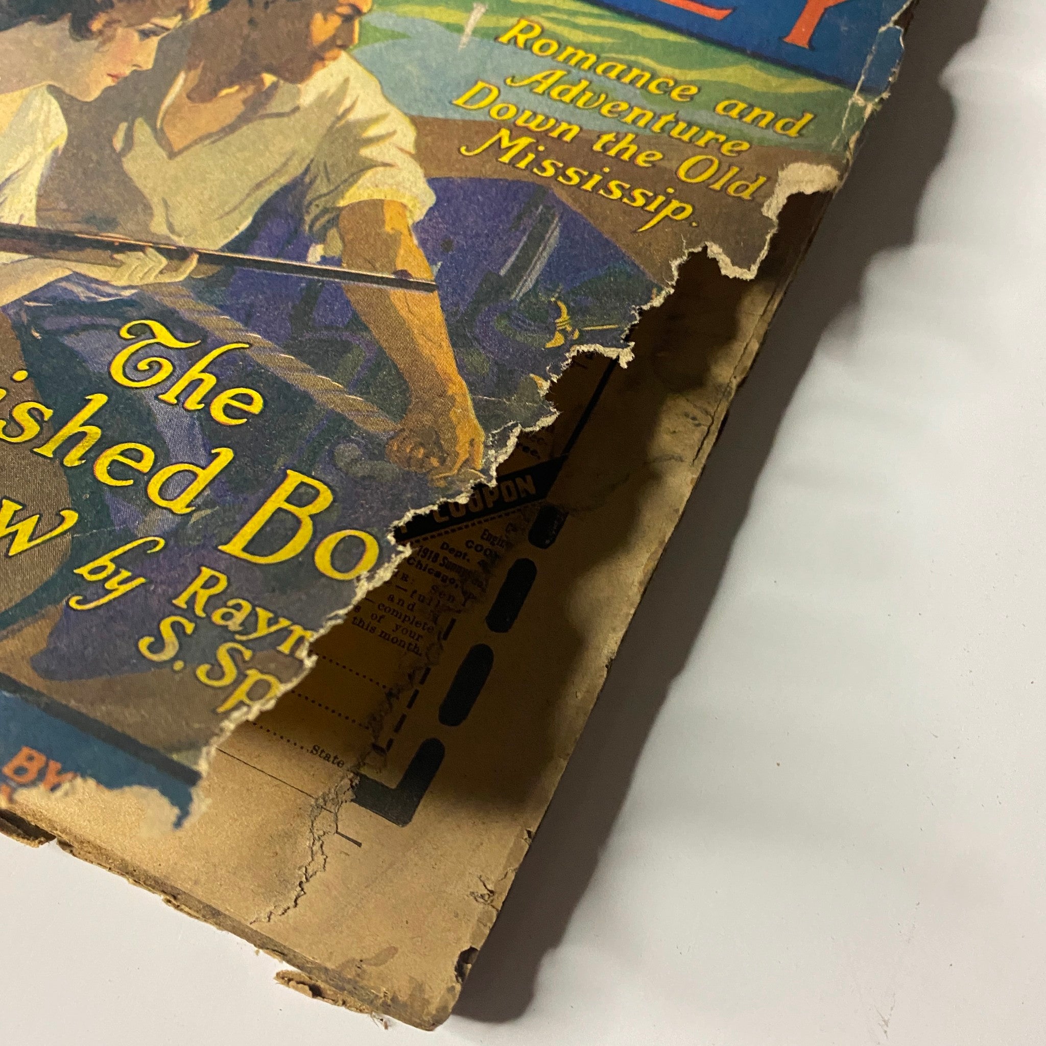 Close-up of the damaged edge of the Argosy All-Story Weekly magazine from September 4, 1920, featuring 'The Varnished Boat Soft-Paw' by Raymond S. Spears, illustrating wear and tear while retaining historical value.