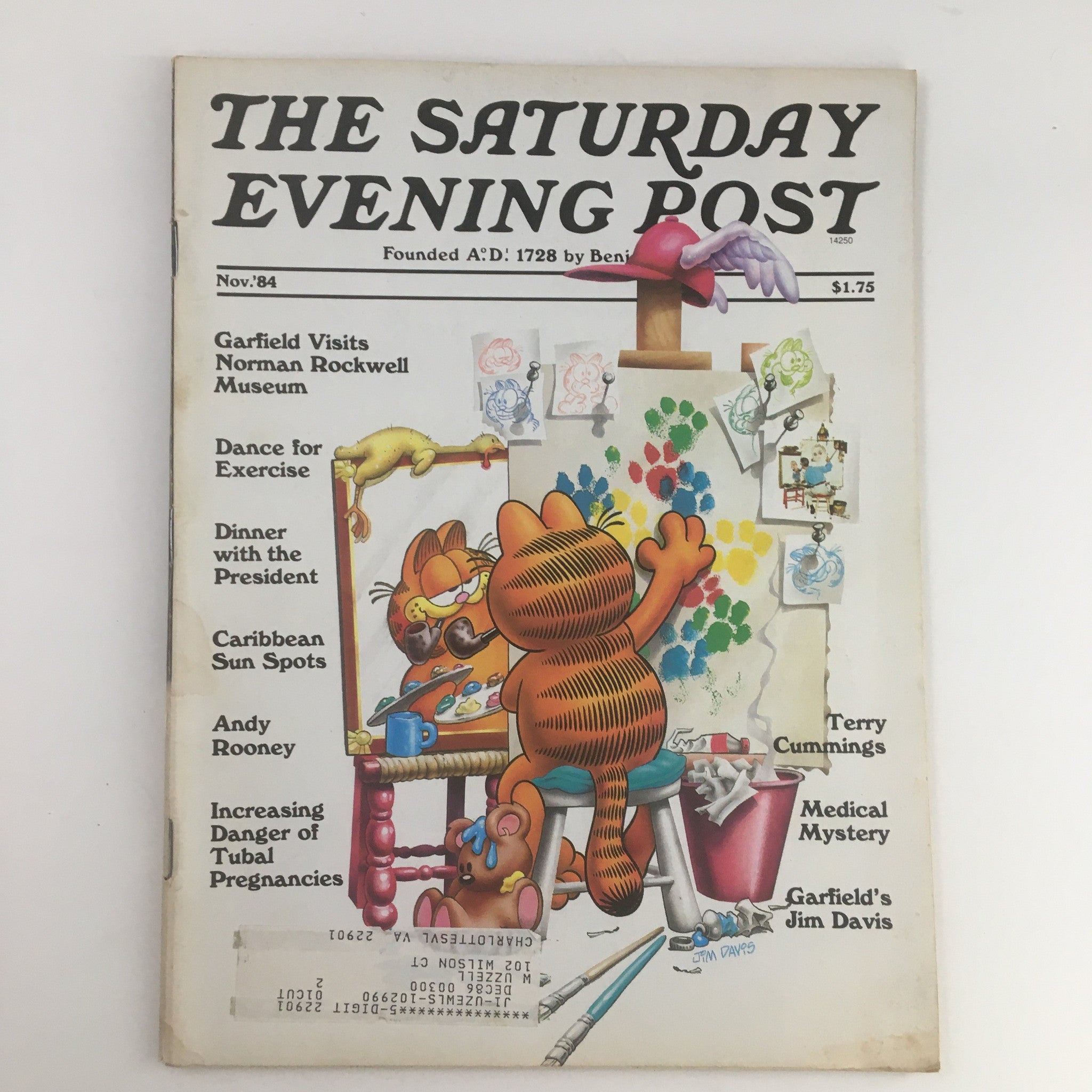 Cover of The Saturday Evening Post November 1984 featuring Garfield Visits Norman Rockwell Museum, showcasing Garfield with a paintbrush and palette, highlighting classic American art.