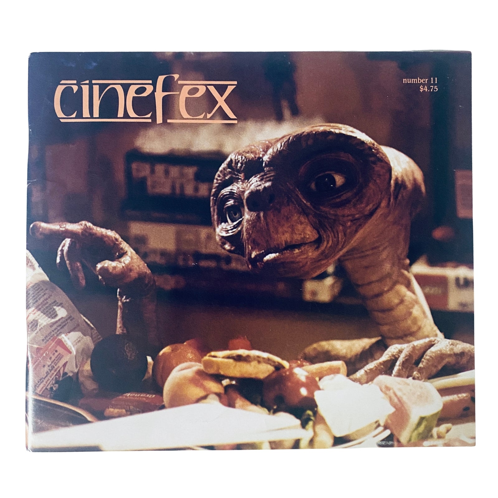 Cinefex Magazine January 1983 No. 11 cover featuring E.T. the Extra-Terrestrial, showcasing the character gazing at food. A vintage collectible magazine in very good condition, priced at $4.75.