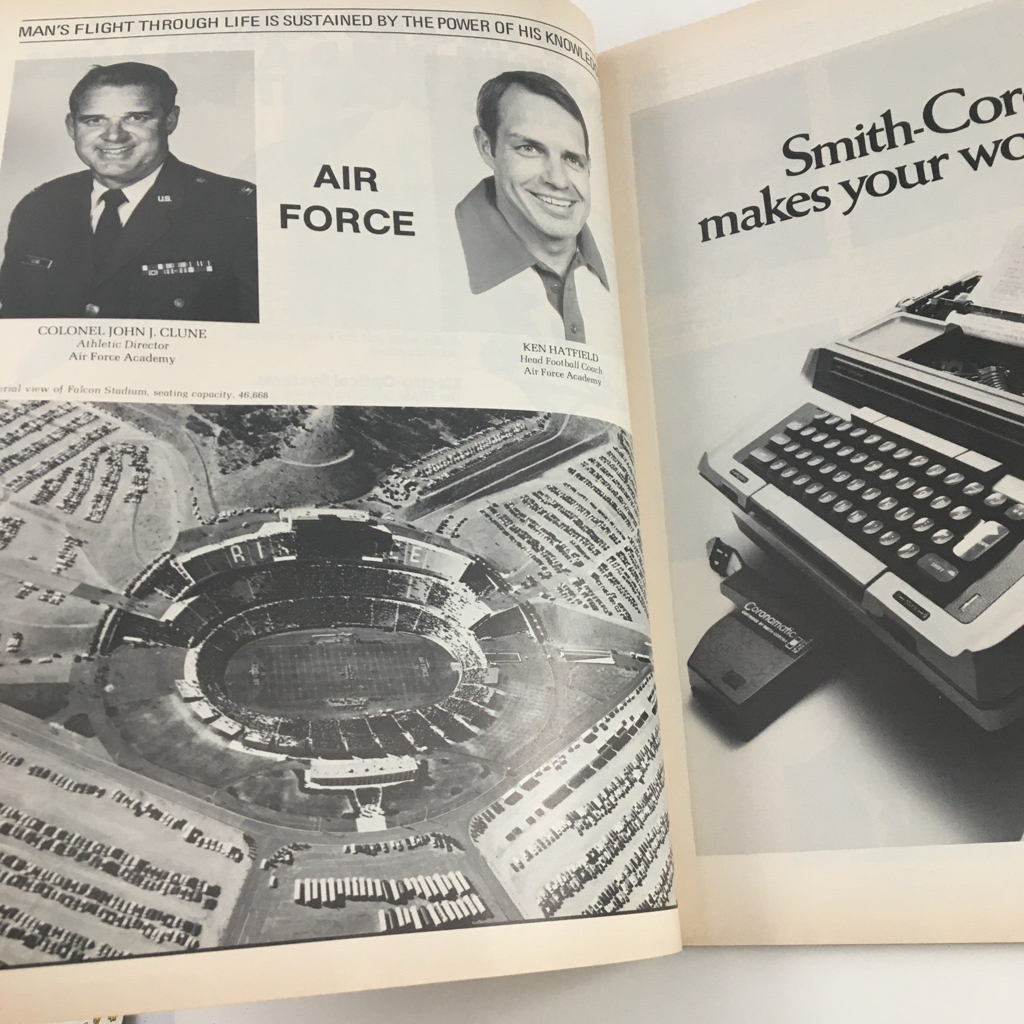 Photo of Colonel John J. Clune and Head Football Coach Ken Hatfield with aerial view of Falcon Stadium, featured in the 1981 Navy Air Force Navy-Marine Corps Memorial Stadium Official Program.