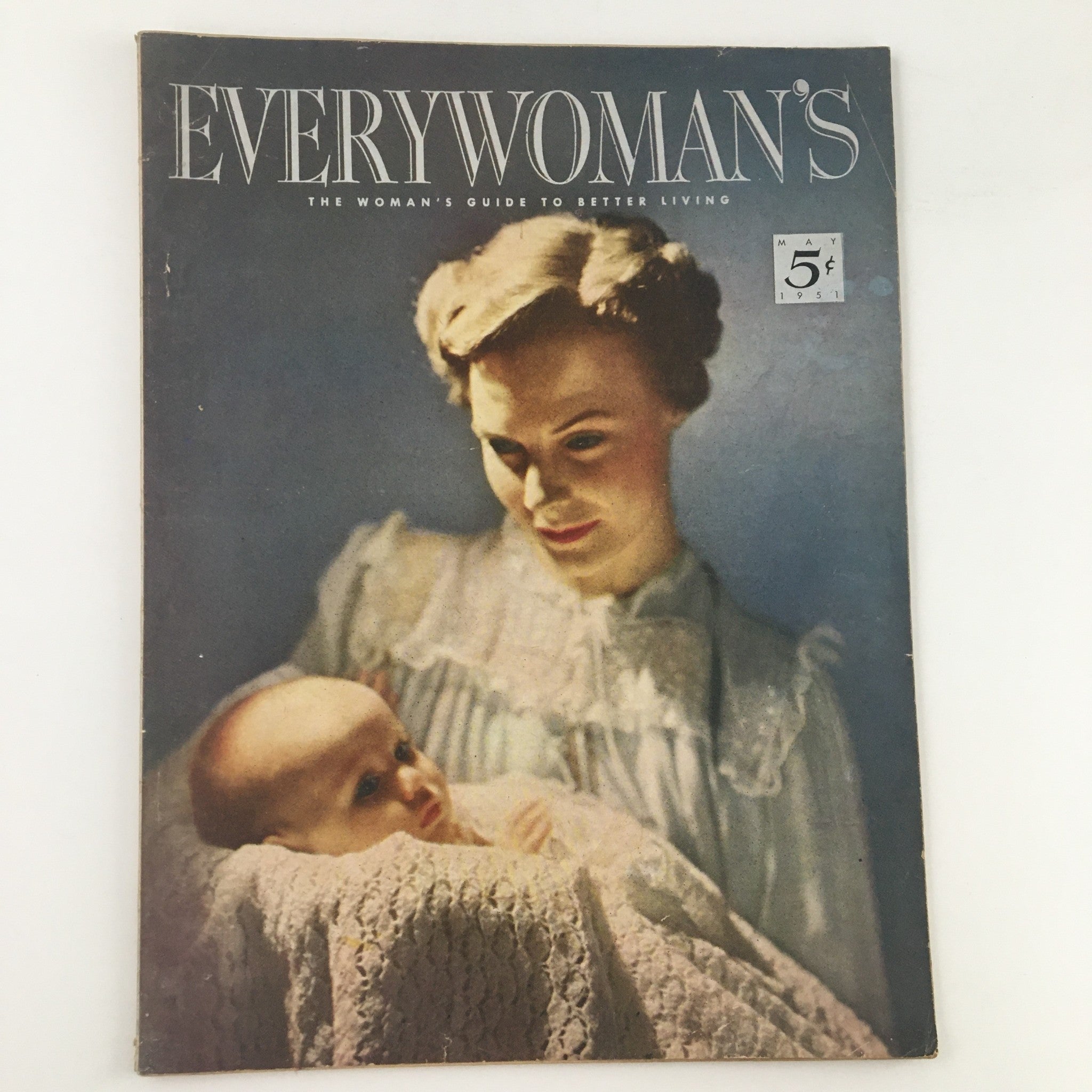 Cover of Everywoman's Magazine May 1951 featuring the title 'The Girl In Your Dreams is You', showcasing a vintage portrait of a woman holding a baby.