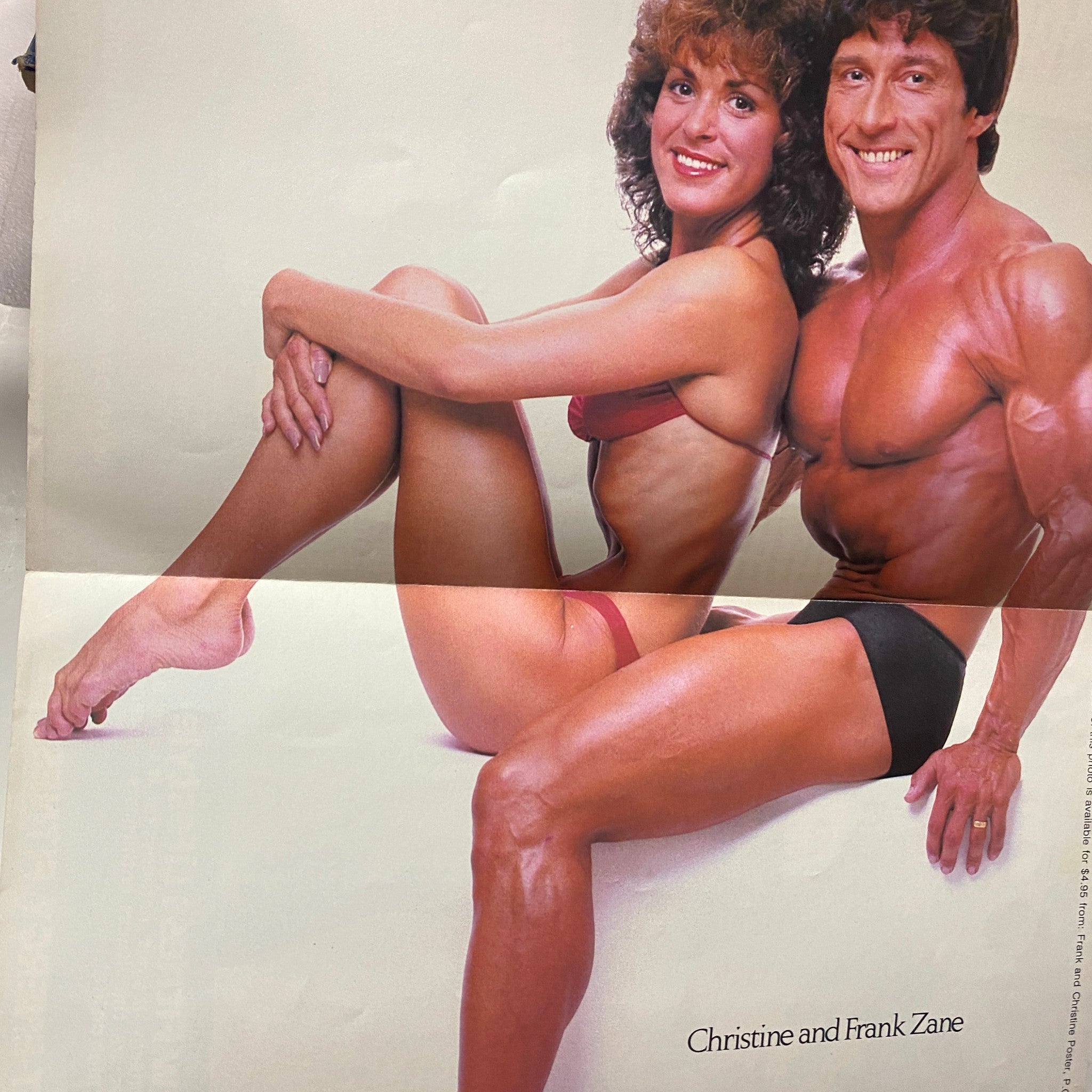 Centerfold poster of Joe Weider's Muscle Magazine April 1980 showcasing bodybuilders Christine and Frank Zane in a striking pose, highlighting the magazine's focus on bodybuilding culture.