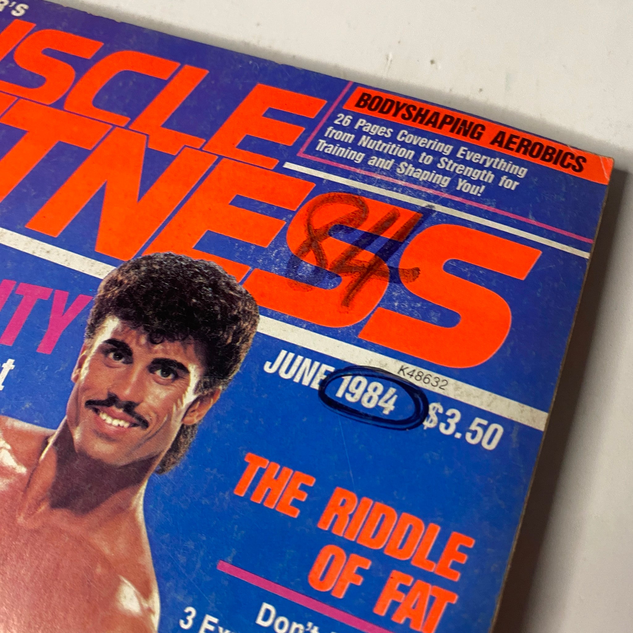 Close-up of the top corner of the Muscle & Fitness Magazine June 1984 cover, showcasing details like price and issue date.