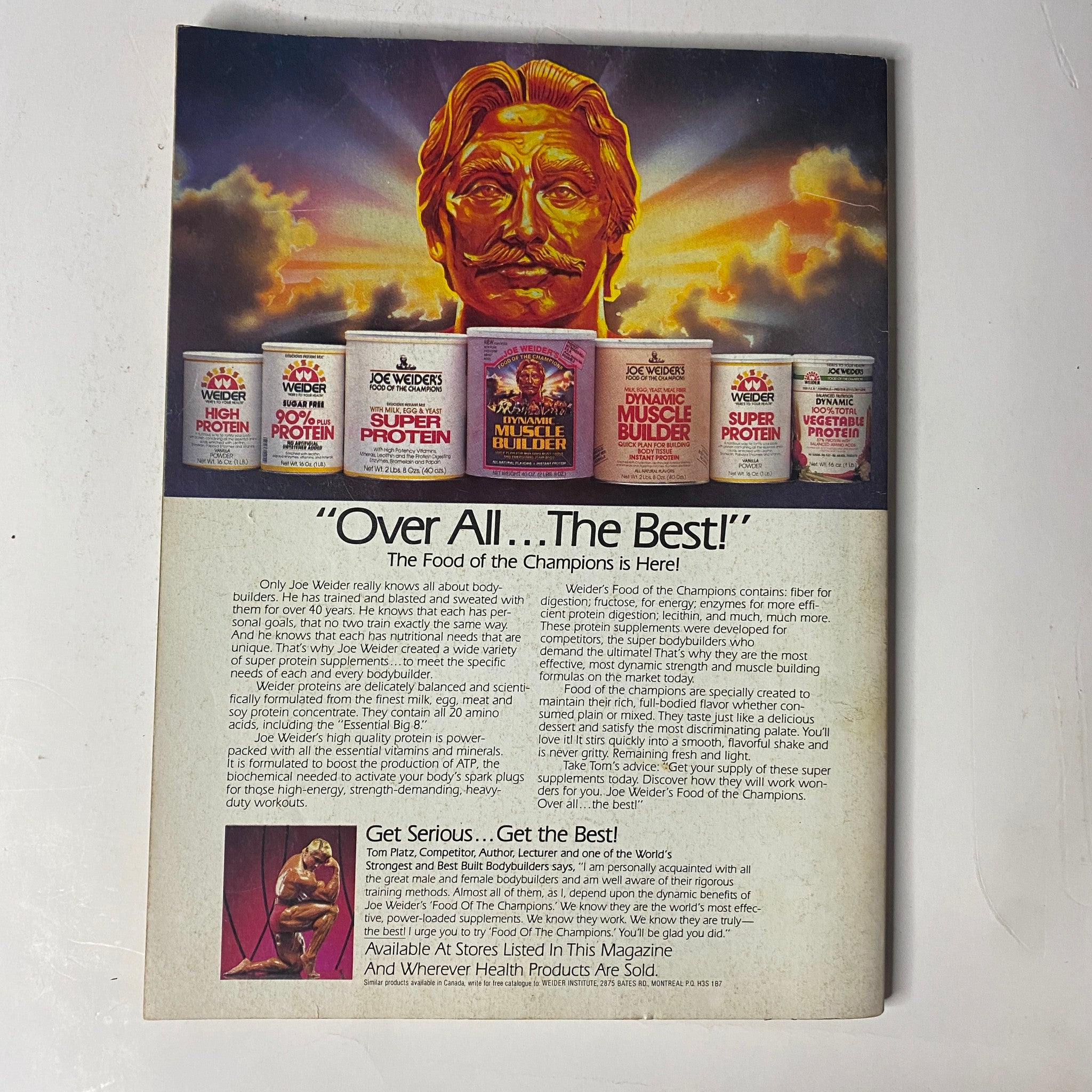 Back cover of Muscle & Fitness Magazine June 1984 featuring a vibrant advertisement for health products, titled 'Over All ...The Best! The Food of the Champions is Here!' showcasing protein supplements with a golden statue representation.
