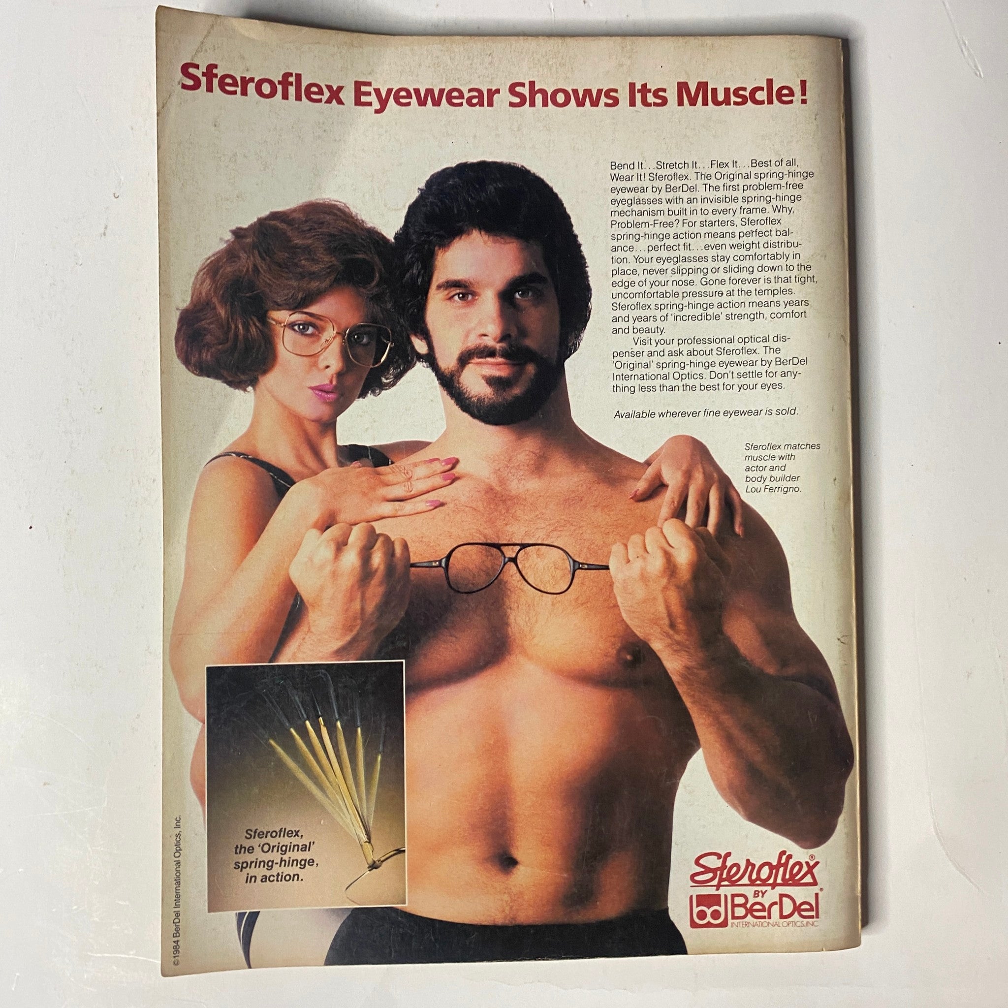 Sferoflex Eyewear advertisement from Muscle & Fitness Magazine September 1984, featuring a model and a man exhibiting muscles while showcasing eyewear products.