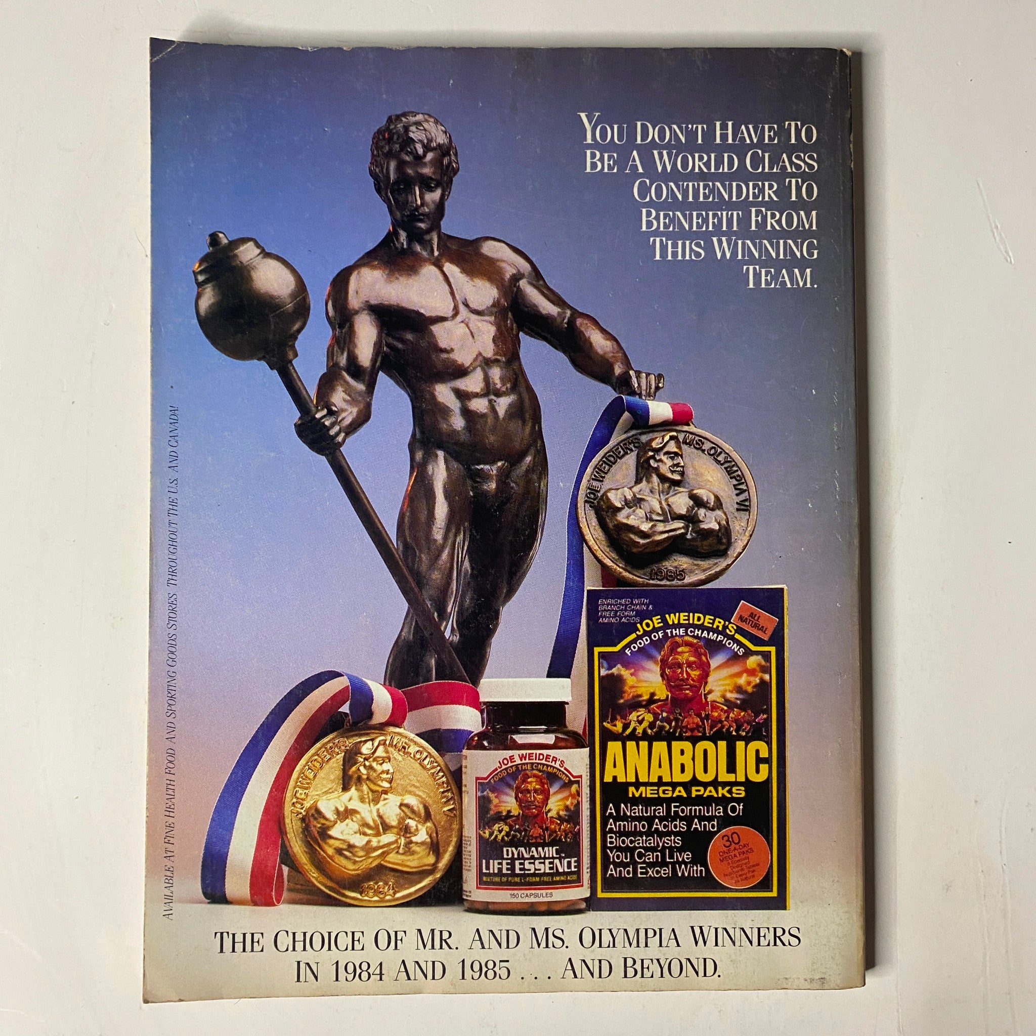 Back cover of Muscle & Fitness Magazine, September 1986, displaying a statue of a weightlifter and various bodybuilding awards.